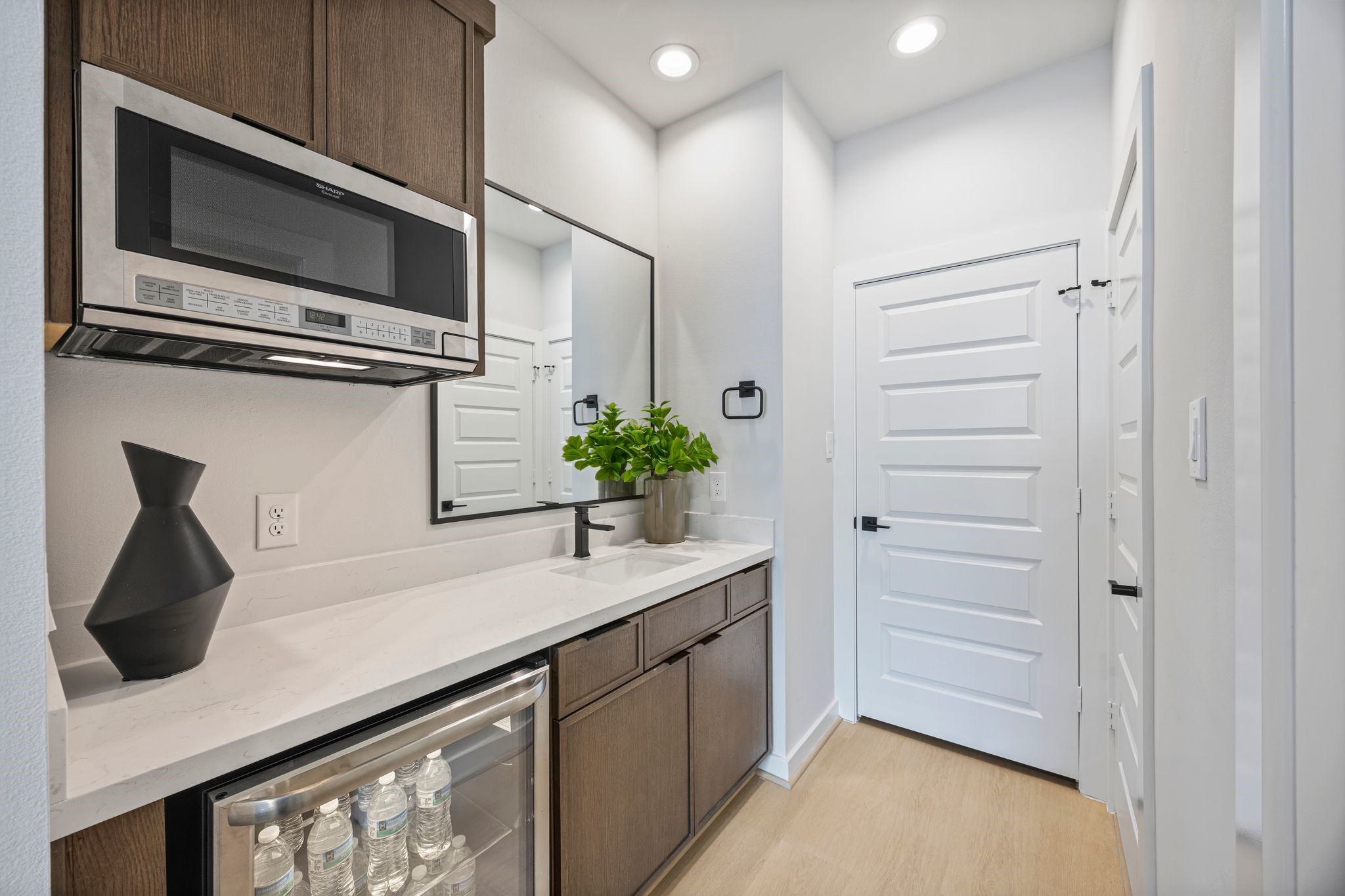 Elegant guest suite kitchenette with modern cabinetry, sleek appliances, and a stylish countertop, perfect for comfort and convenience. **Model Home of similar layout & finishes.**