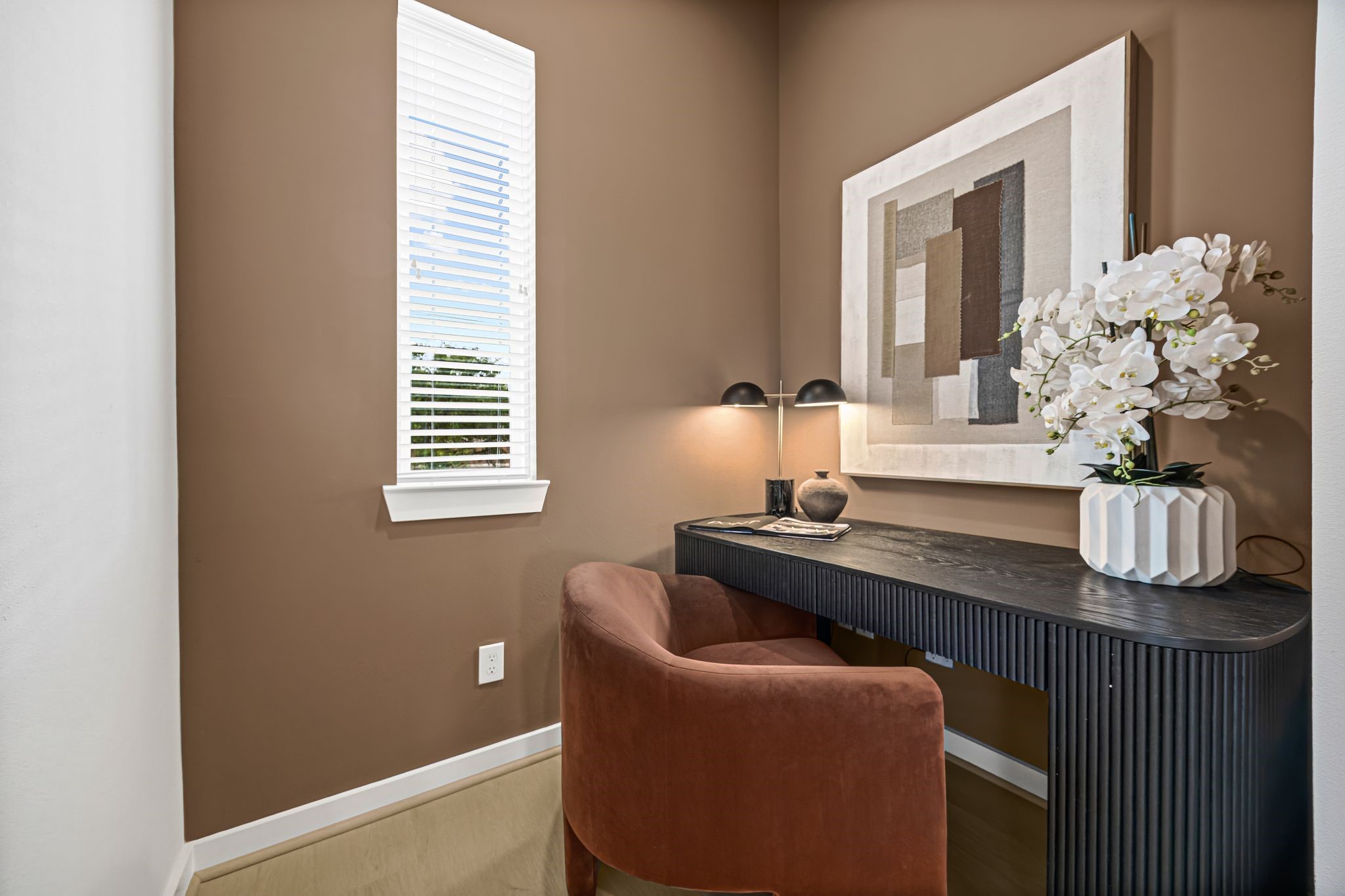 Discover a cozy and sophisticated study featuring a sleek desk, stylish decor, and ample natural light, perfect for focused work or creative inspiration. **Model Home of similar layout & finishes.**