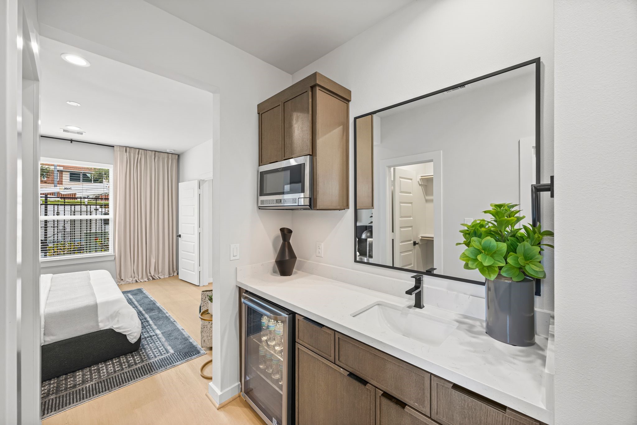 Experience the convenience of a stylish guest suite kitchenette, perfect for hosting with its modern amenities and sleek design. **Model Home of similar layout & finishes.**
