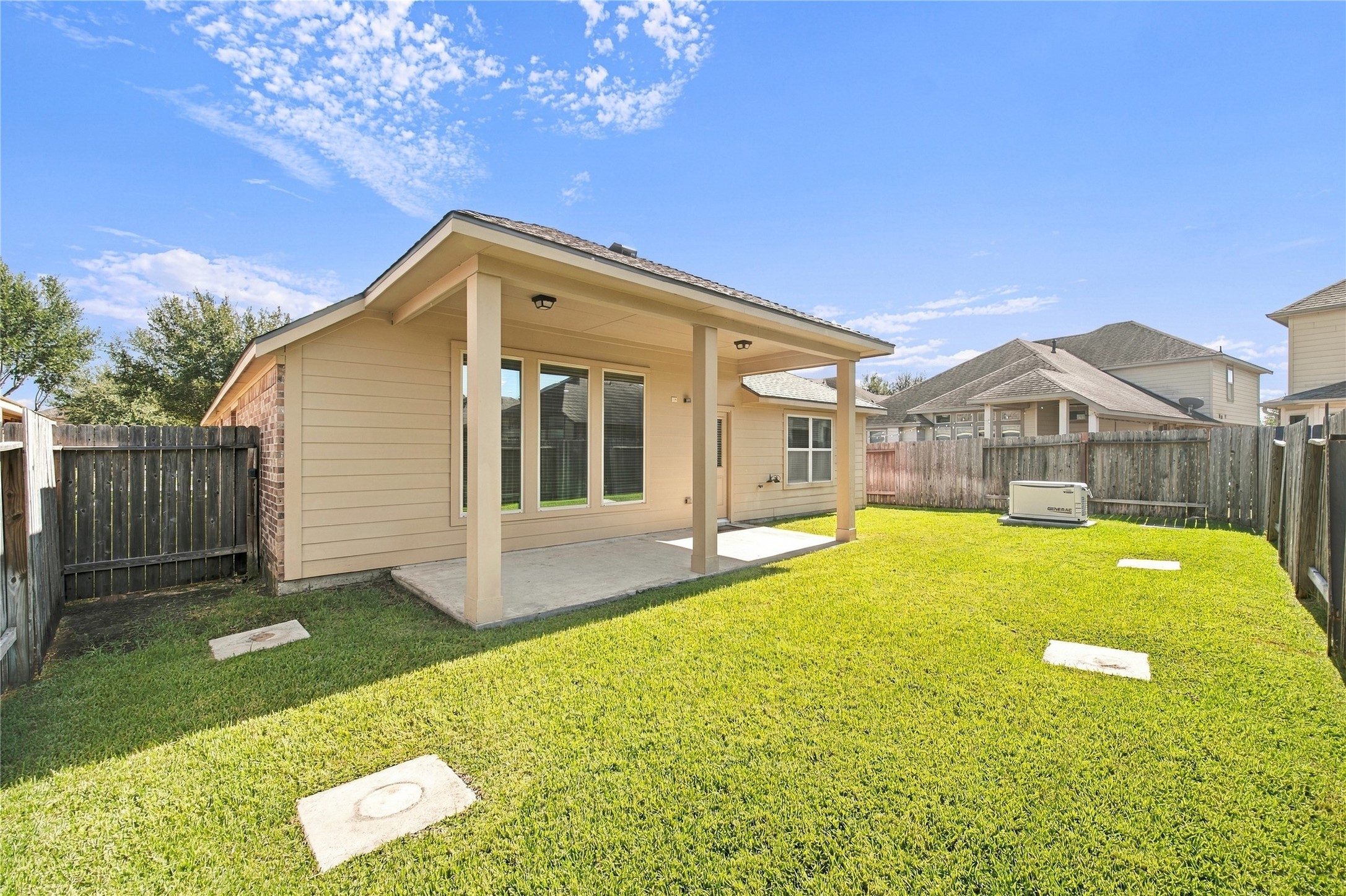 The covered back patio offers a wonderful space to relax, unwind, and enjoy the outdoors.