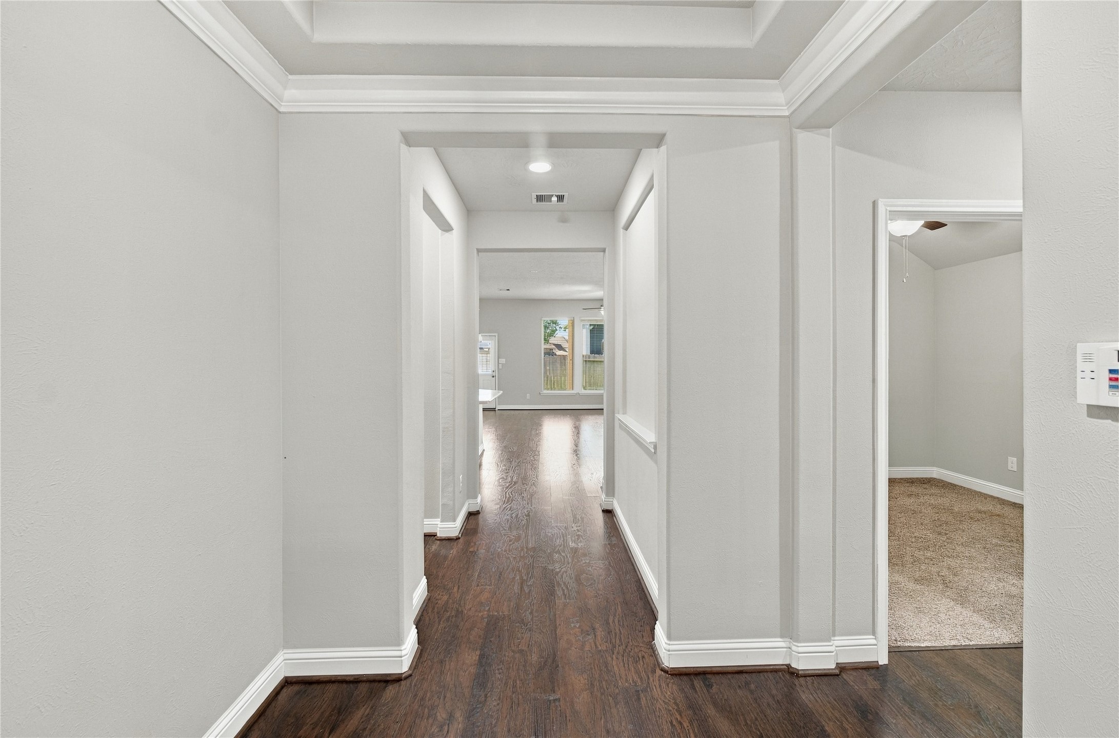 Stepping through the front door, you are welcomed by beautiful wood flooring that flows throughout the home, creating a warm and cohesive feel.