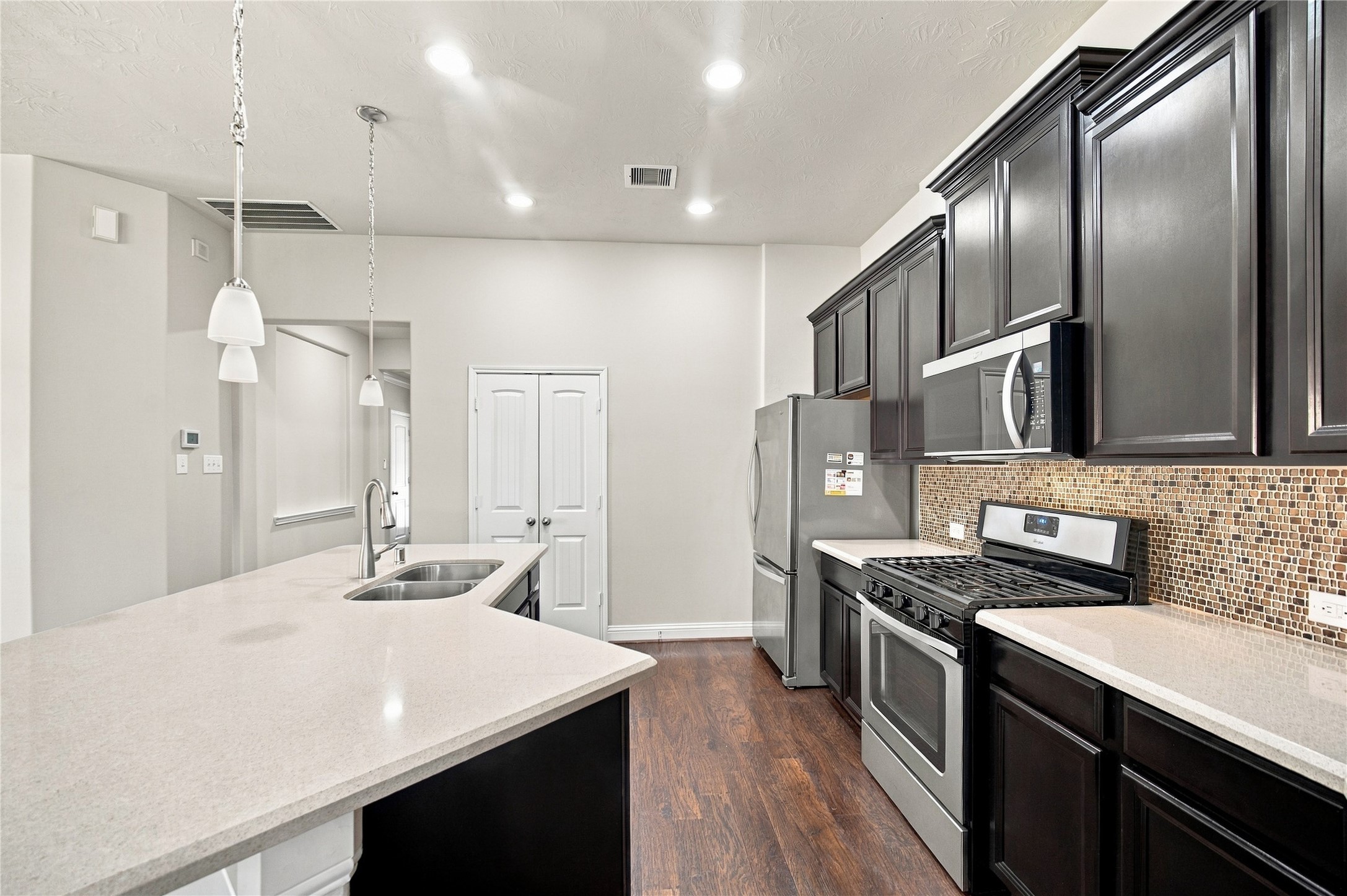 Pendant and recessed lighting add the perfect finishing touches to the kitchen.