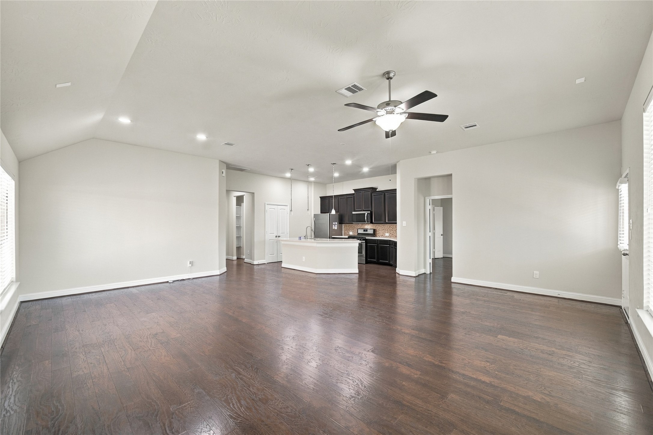 The open layout creates a seamless flow between the family room and kitchen, making the space ideal for everyday living and entertaining.