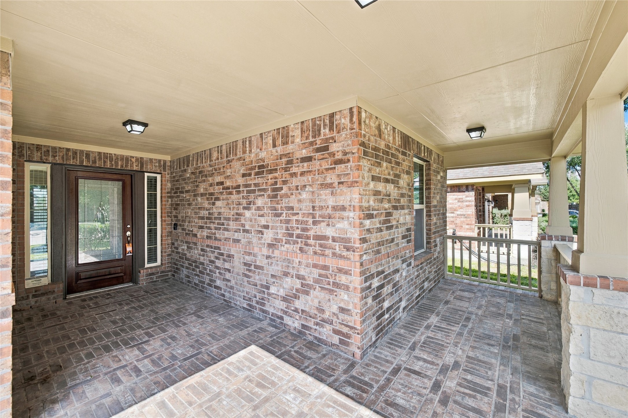 An inviting covered brick front porch adds charm and curb appeal.