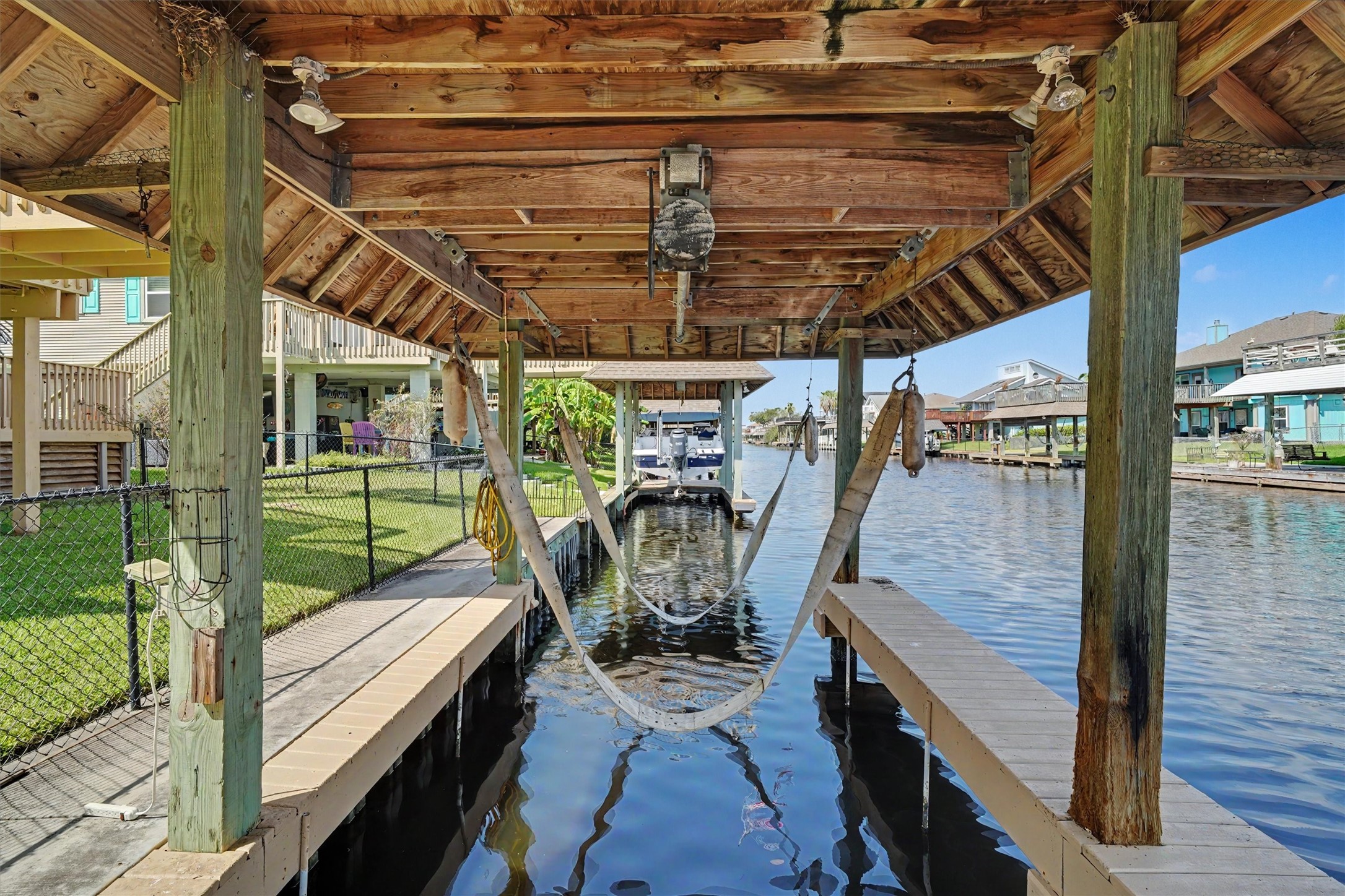 Boathouse with boatlift. Facing towards the lateral canal where the boating exit sits Boathouse with boatlift. Facing towards the lateral canal where the boating exit sits