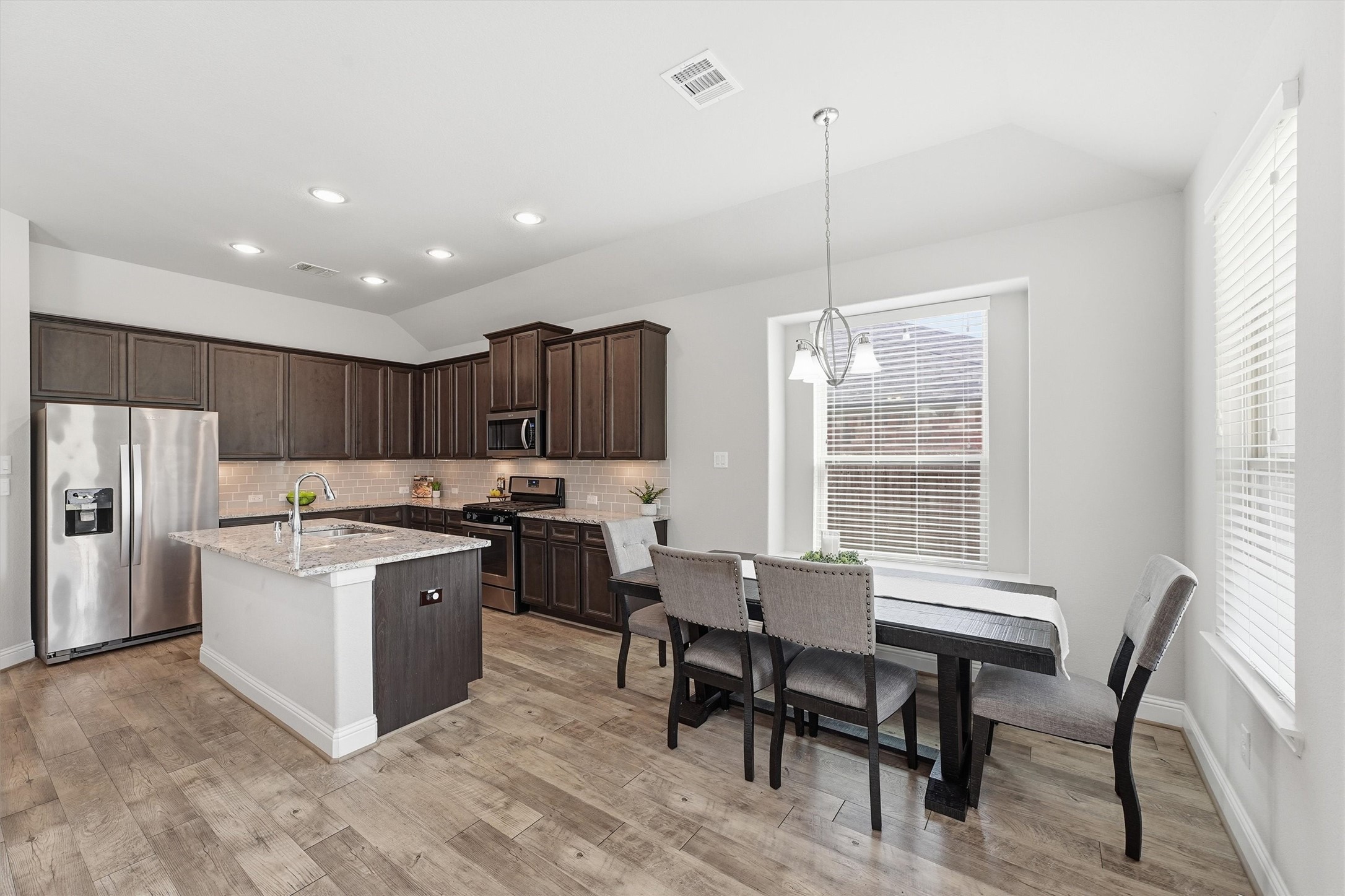 Casual dining area with bay window seating and convenient access to the kitchen.