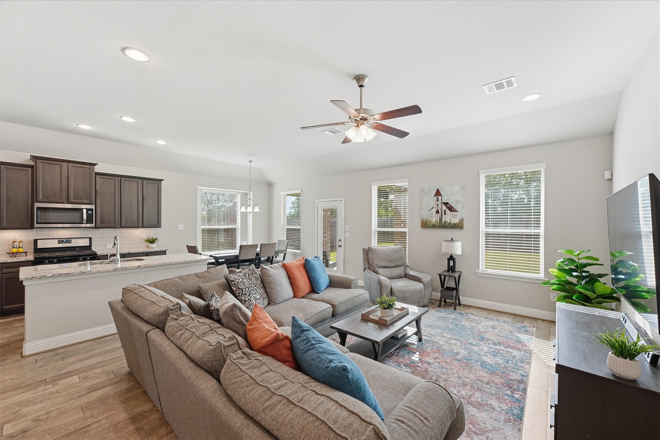 Light-filled family room with high ceilings and an open connection to the kitchen and dining area. Light-filled family room with high ceilings and an open connection to the kitchen and dining area.