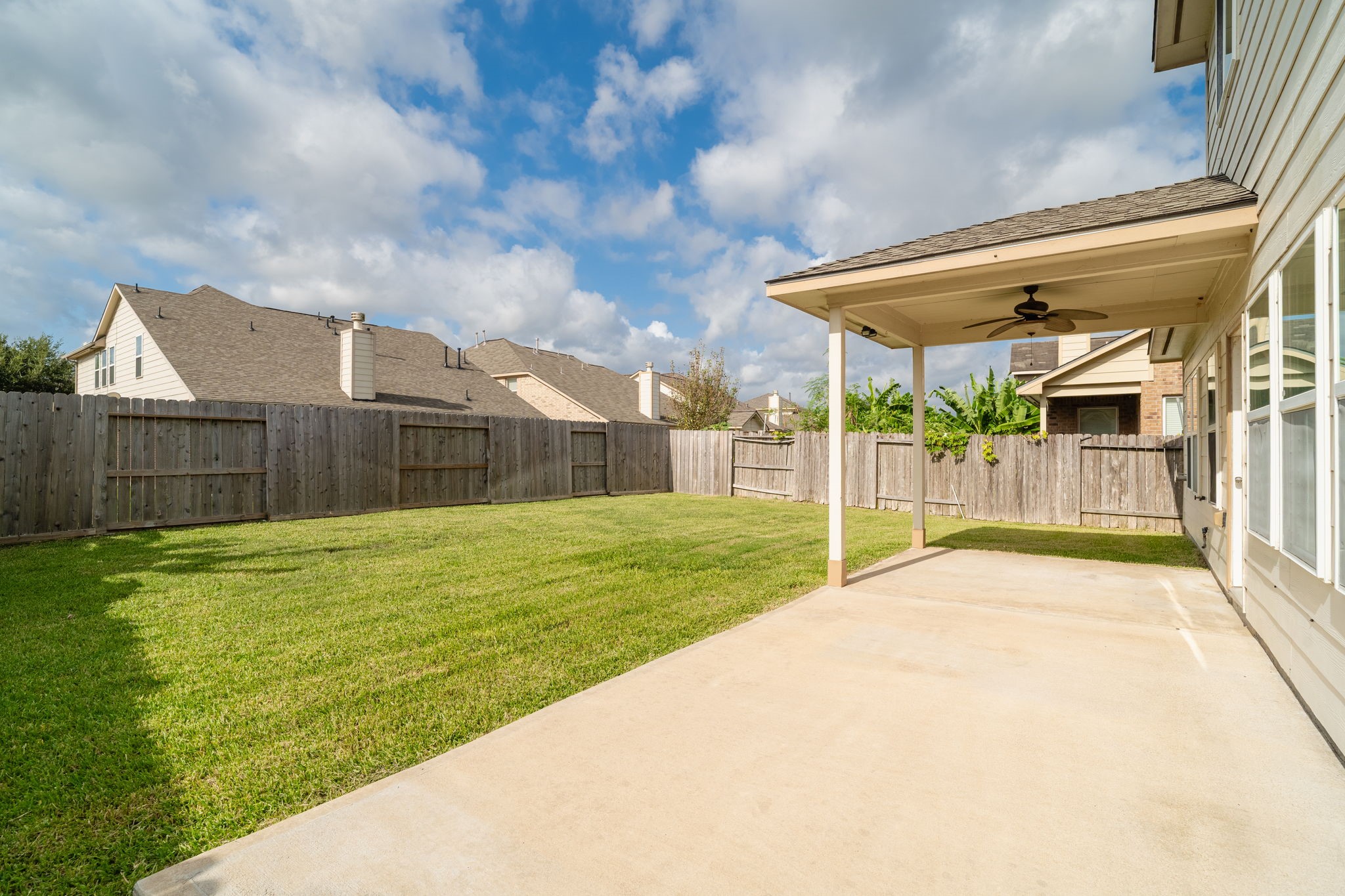 Fully fenced backyard with an expansive lawn, providing plenty of room for outdoor activities, pets or future landscaping.