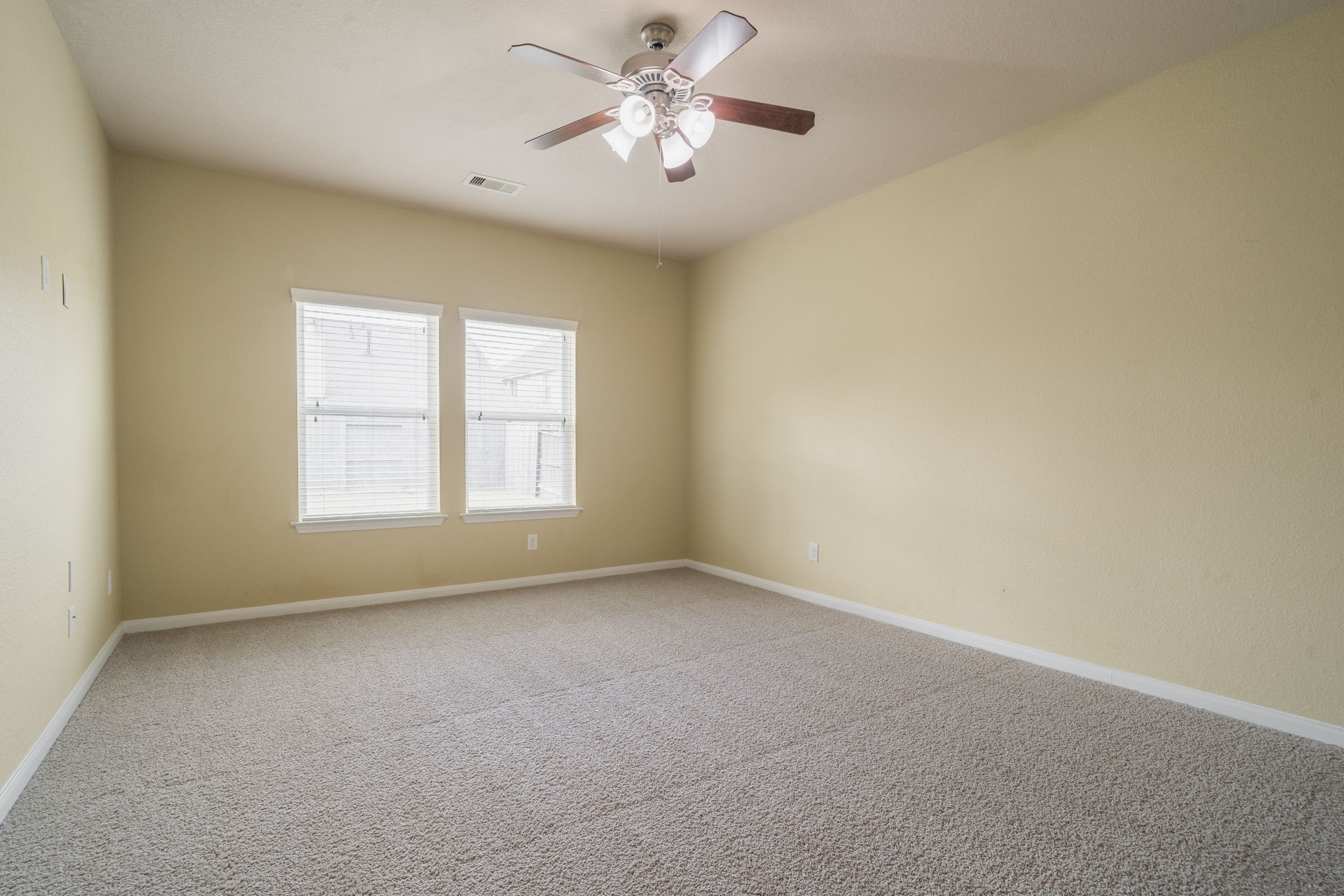 The downstairs primary suite features abundant natural light and a spacious layout.
