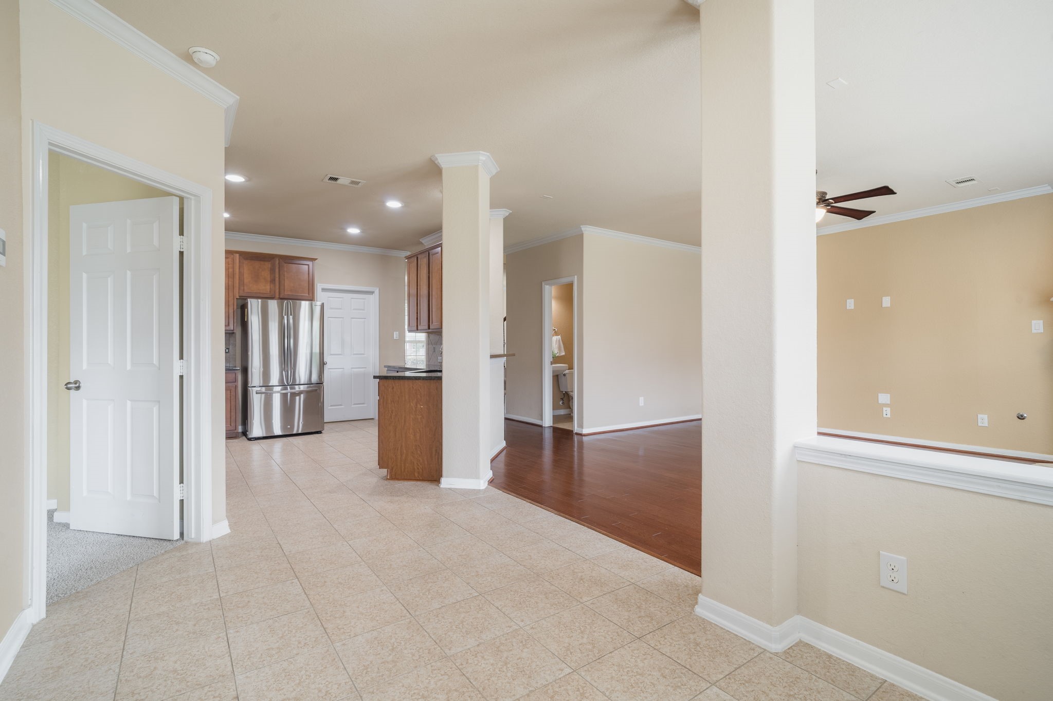 This view highlights the home's open-concept design, connecting the kitchen, breakfast area & family room while maintaining distinct spaces for everyday living.