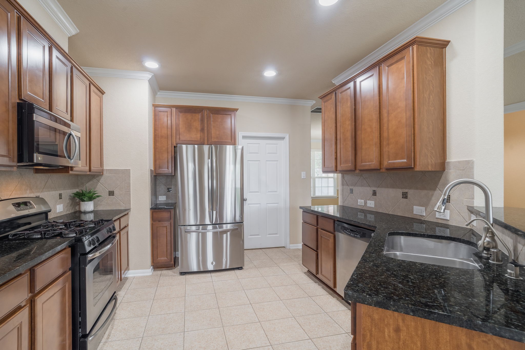 Conveniently located just off the kitchen, the laundry room & pantry area provide additional storage & functionality for everyday living.