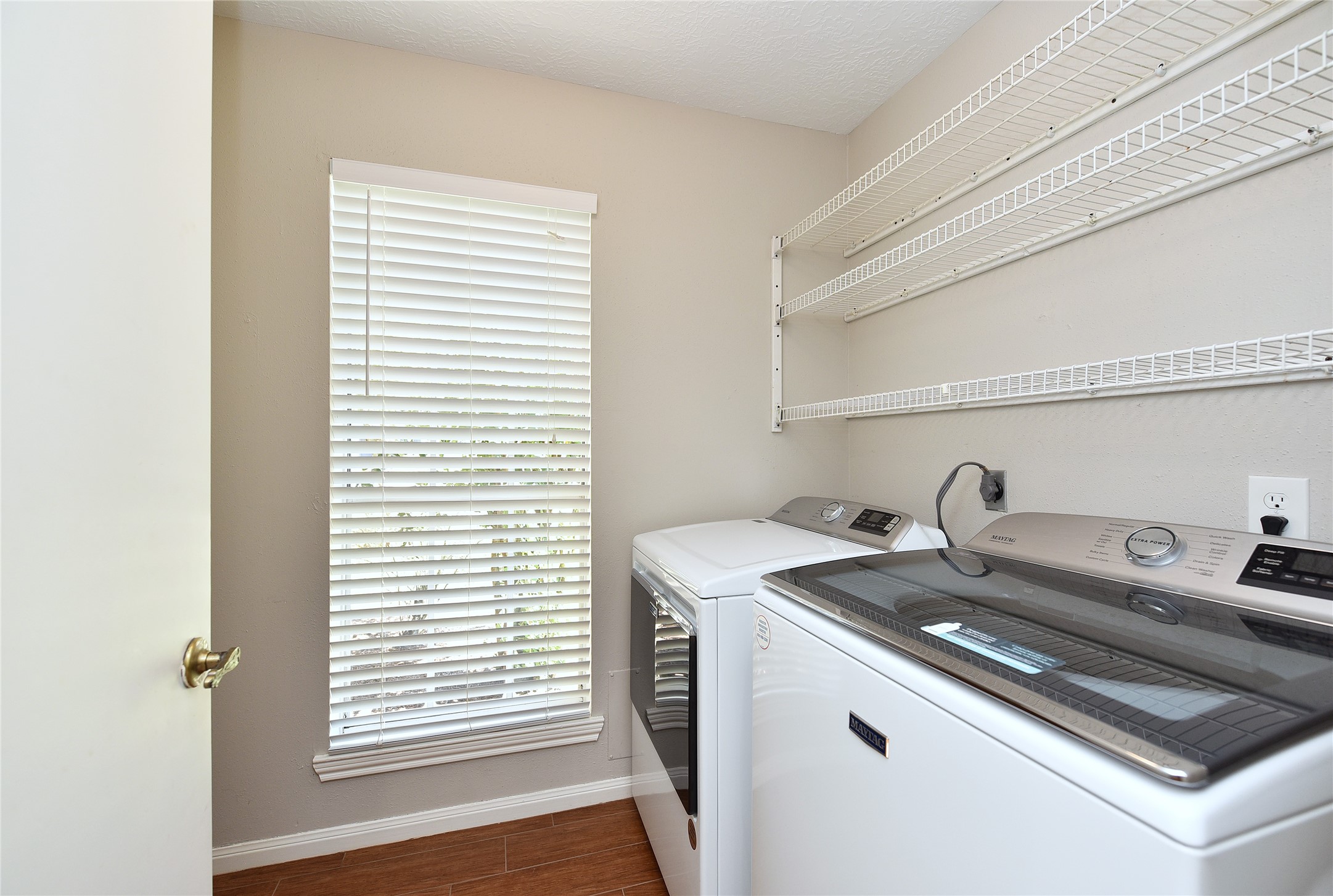 The full-sized utility room has extra space for storage behind the door