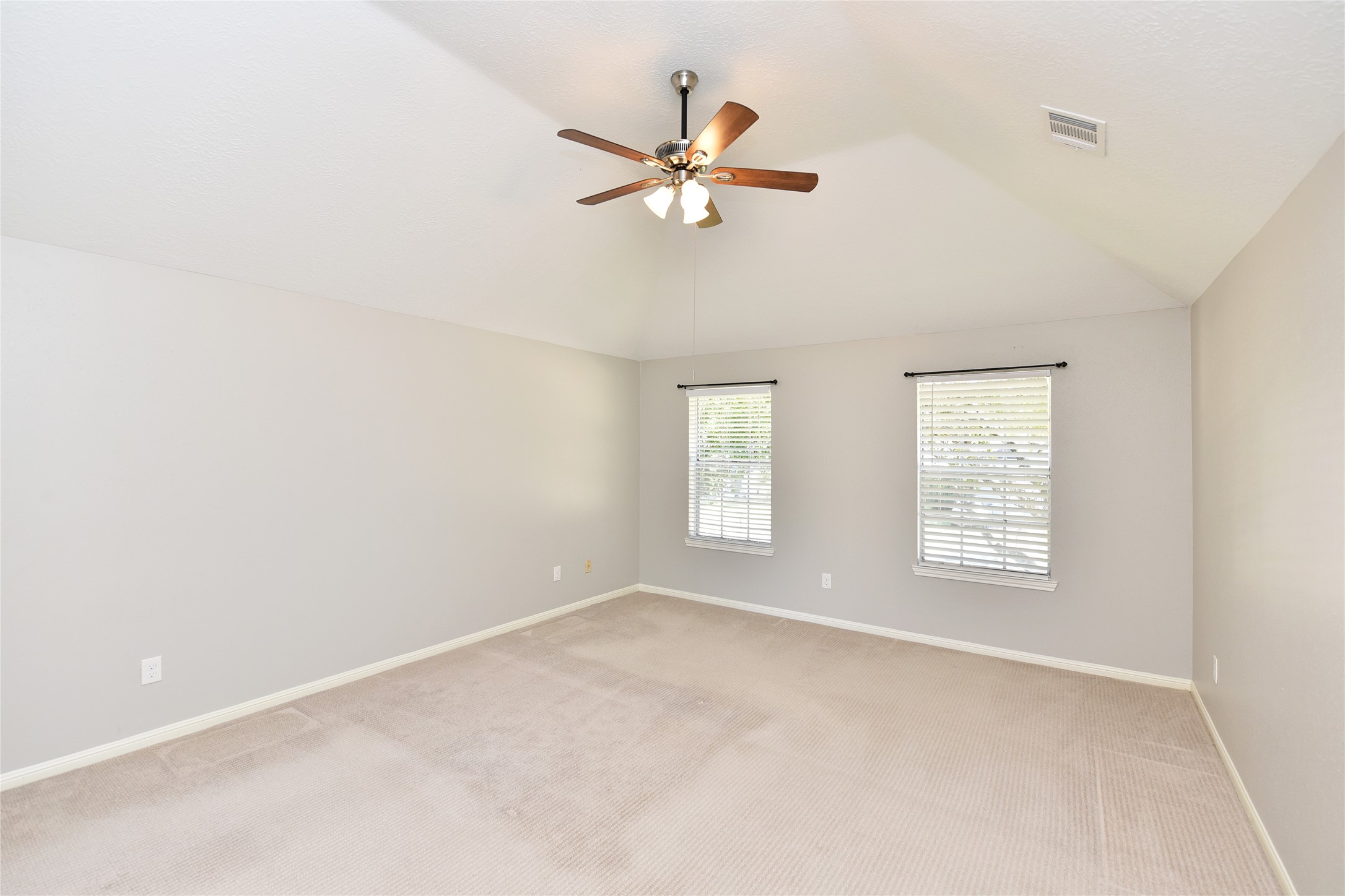Spacious primary bedroom featuring a raised ceiling.