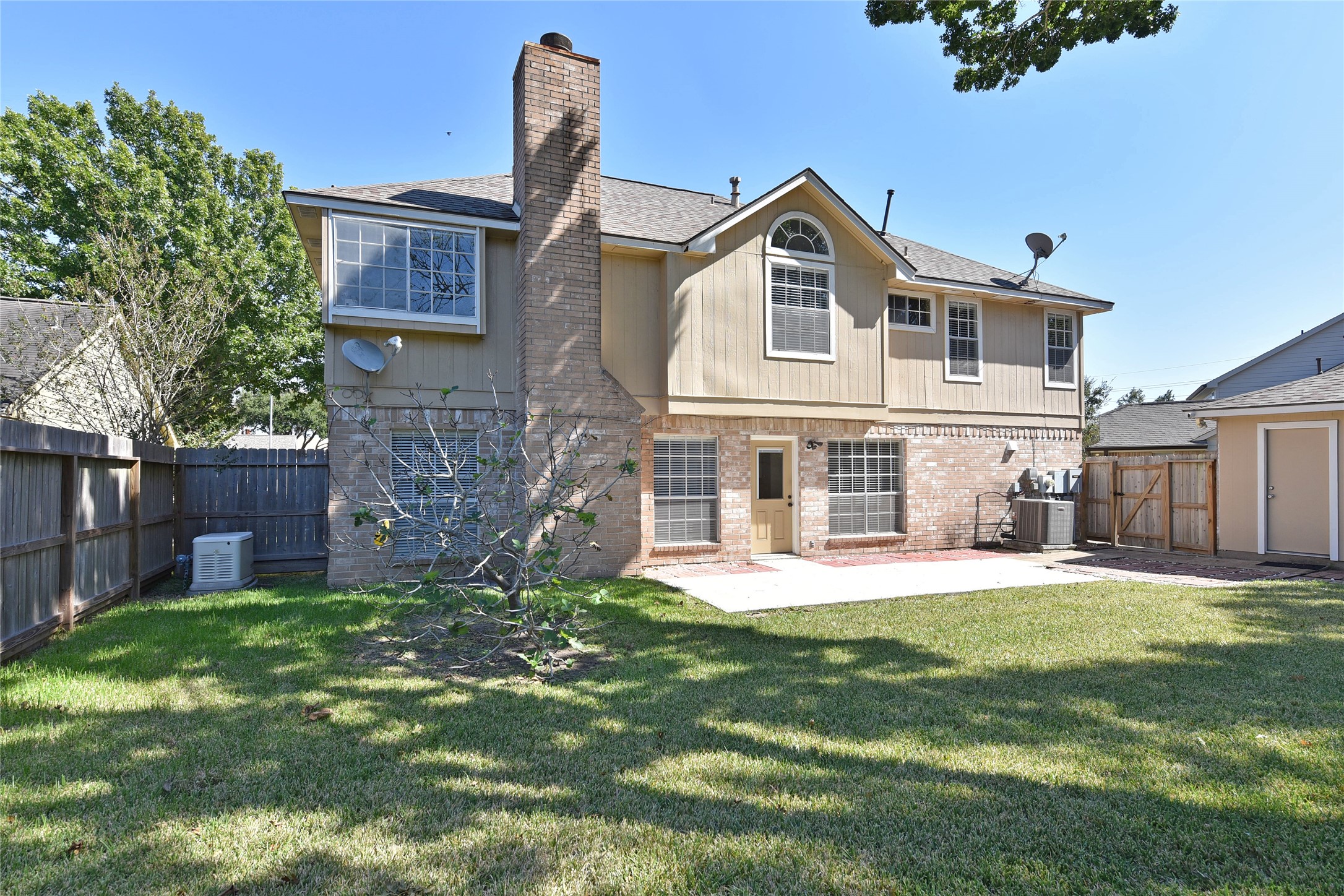 Extended patio and lots of room to play in fenced backyard.