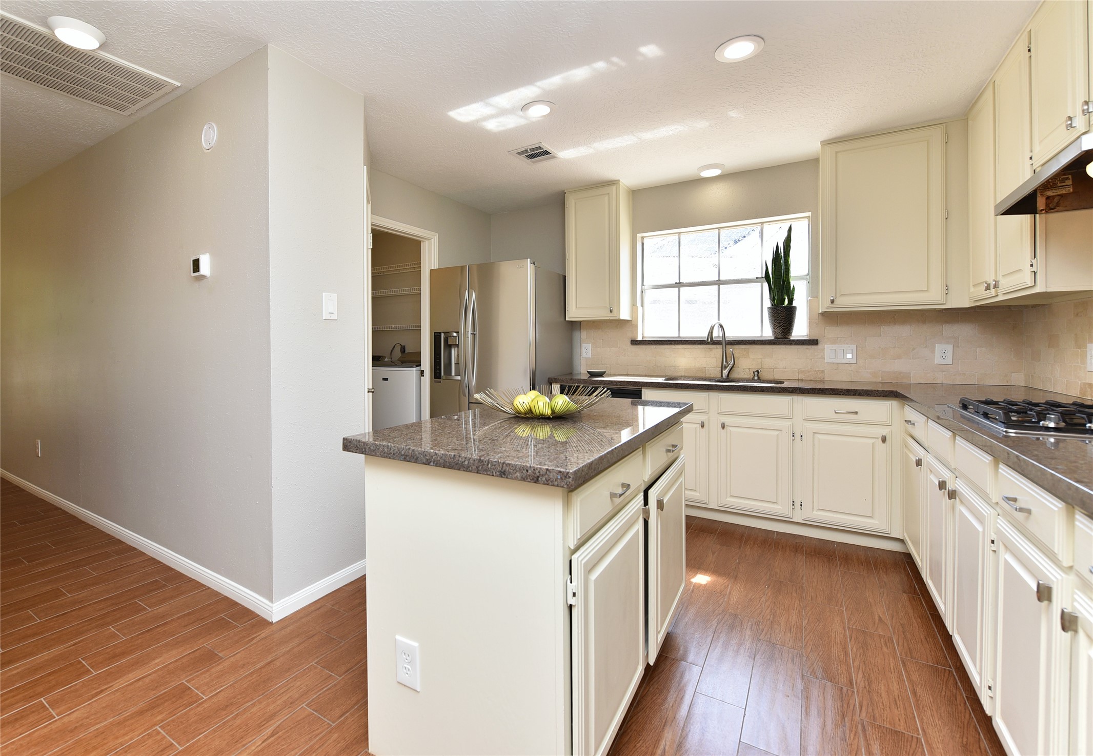 Spacious kitchen featuring a large central island and beautiful granite countertops, perfect for meal preparation and entertaining.