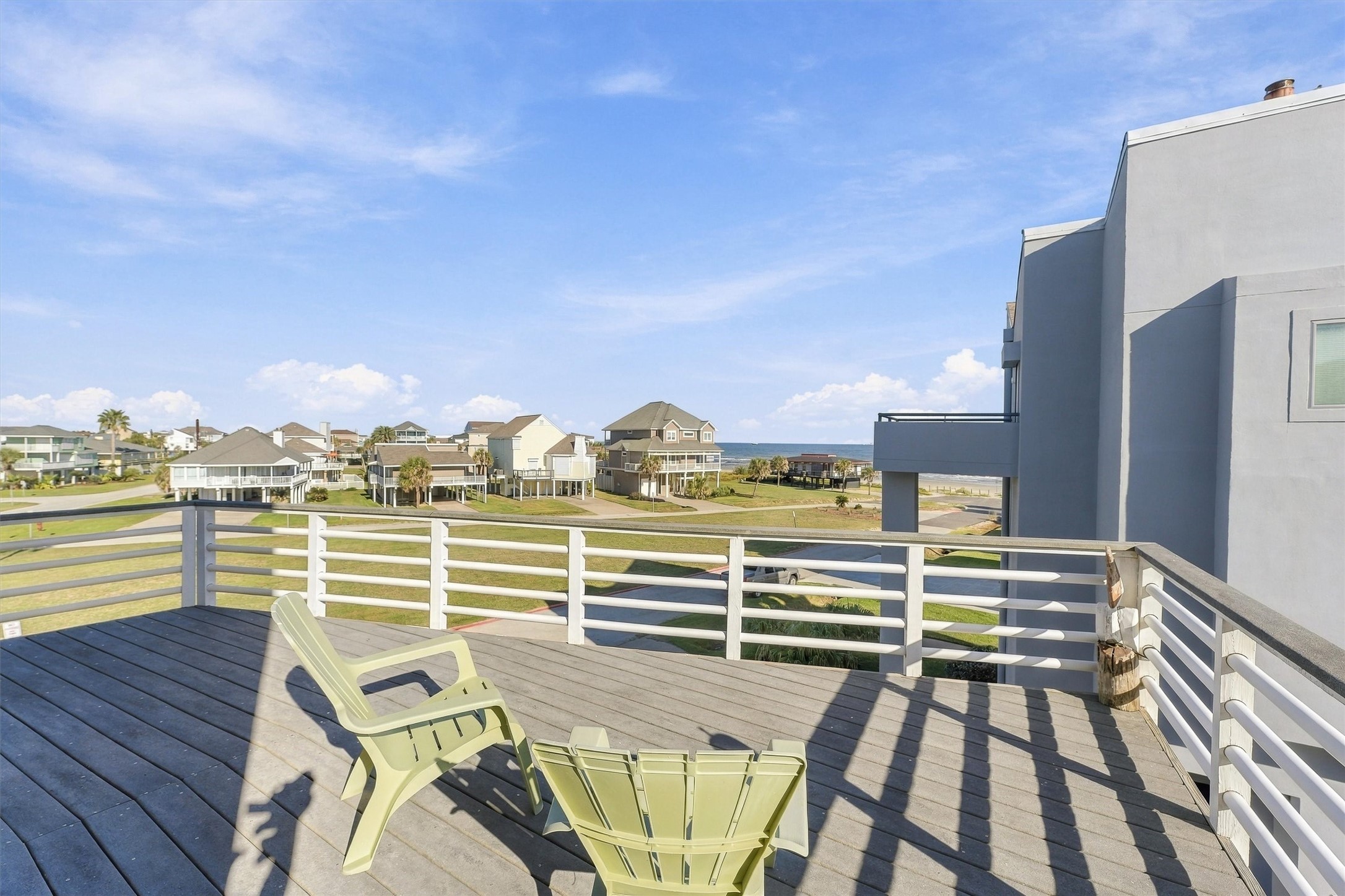 Take a seat beneath the open sky and let the afternoon unfold. This generous balcony offers space to relax, catch the coastal breeze, and enjoy water views across the beachside neighborhood.