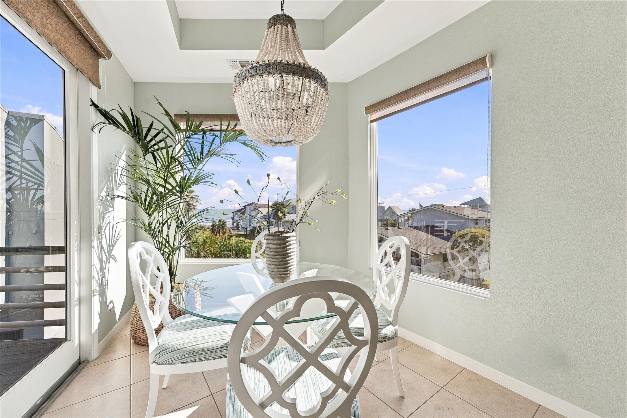 Linger over breakfast as sunlight pours through tall windows with beach views, this charming dining nook makes everyday meals feel like a coastal getaway.