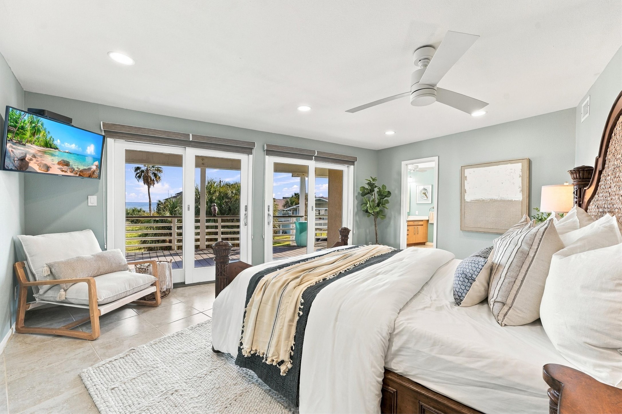 Wake to sparkling water views, then slip outside with your morning coffee. This light-filled primary retreat opens onto a covered balcony, offering a peaceful place to begin and end your island days. Wake to sparkling water views, then slip outside with your morning coffee. This light-filled primary retreat opens onto a covered balcony, offering a peaceful place to begin and end your island days.