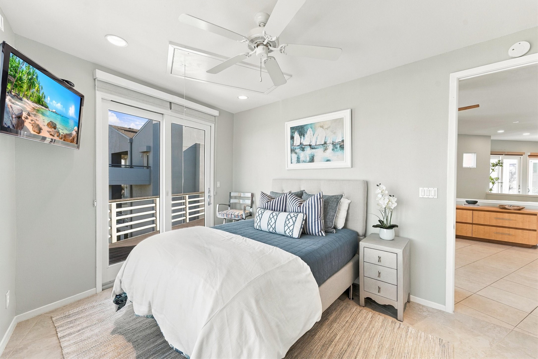 After a day of sunshine, settle into this restful coastal bedroom. Soft blues, crisp whites, and direct balcony access create an inviting retreat for slow mornings and relaxing evenings.