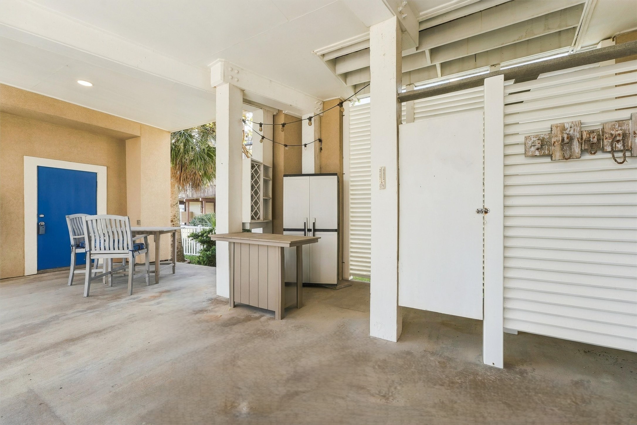 Rinse off in the enclosed outdoor shower, hang up your beach towels, and settle in for the evening. Covered gathering space, a serving counter, and string lights make the transition from beach time to downtime feel effortless.