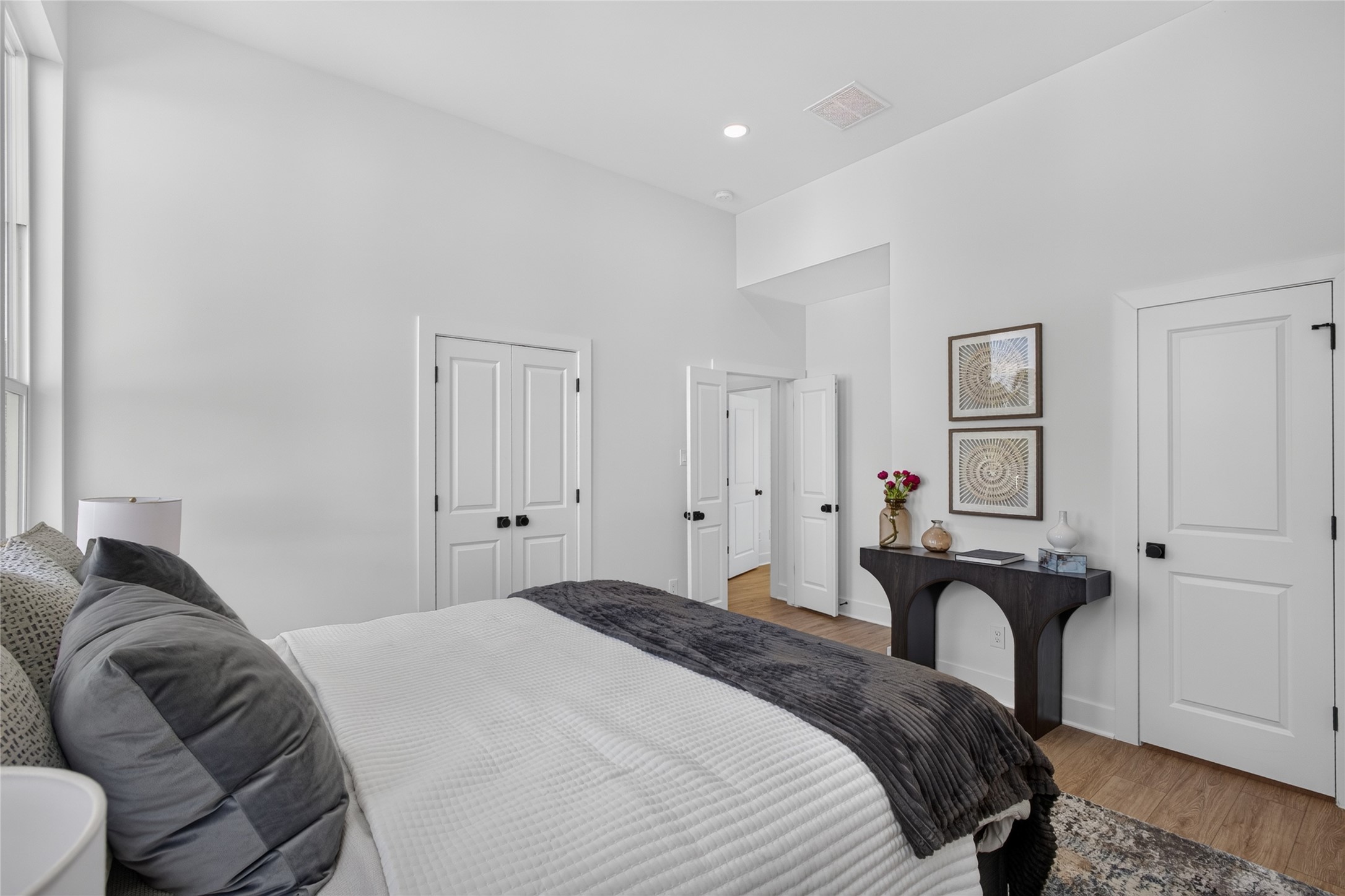 Large primary suite with oversized walk-in closet and luxurious attached full bathroom