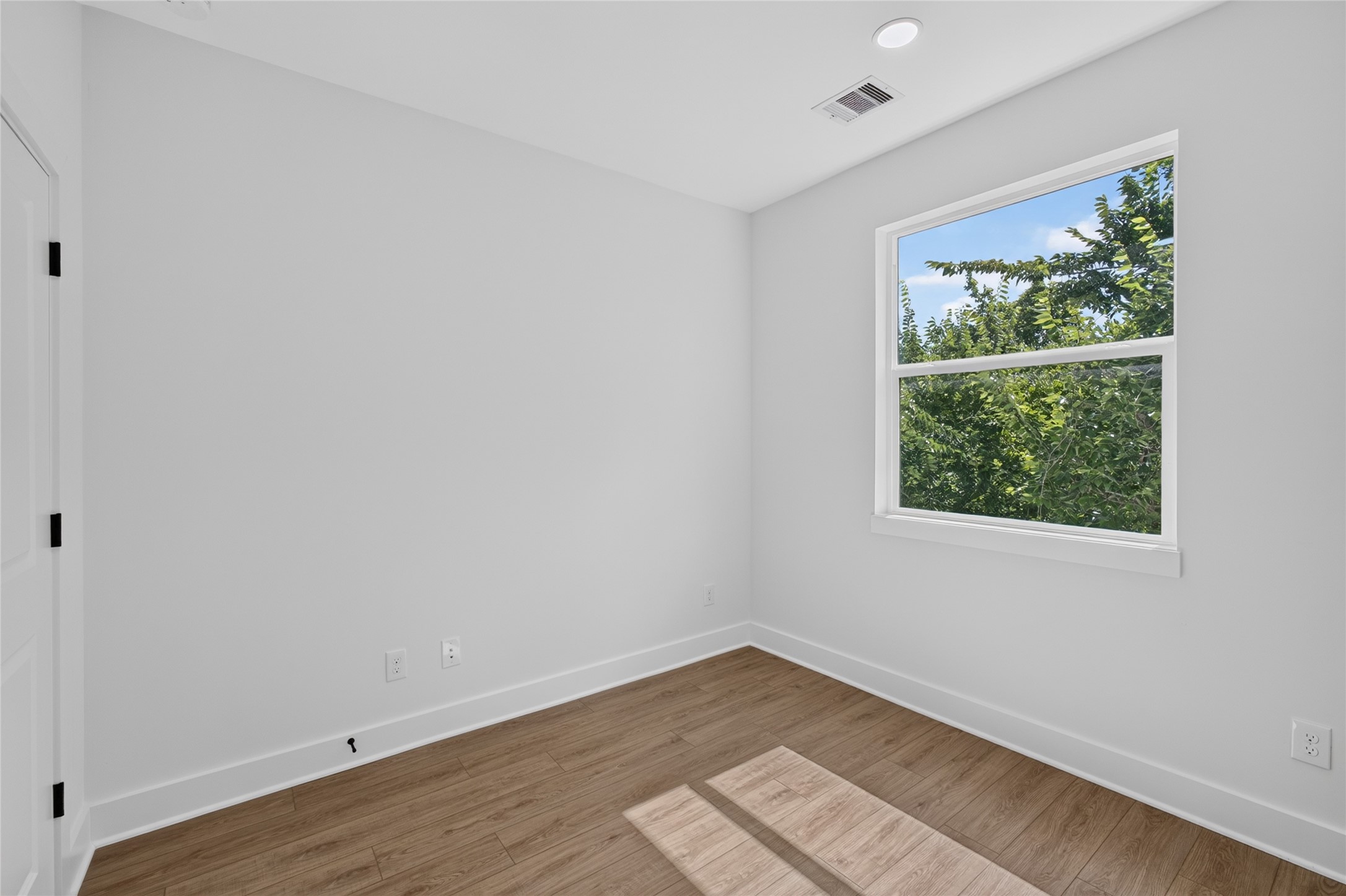 Comfortable third floor secondary bedroom filled with natural light from Low E windows.
