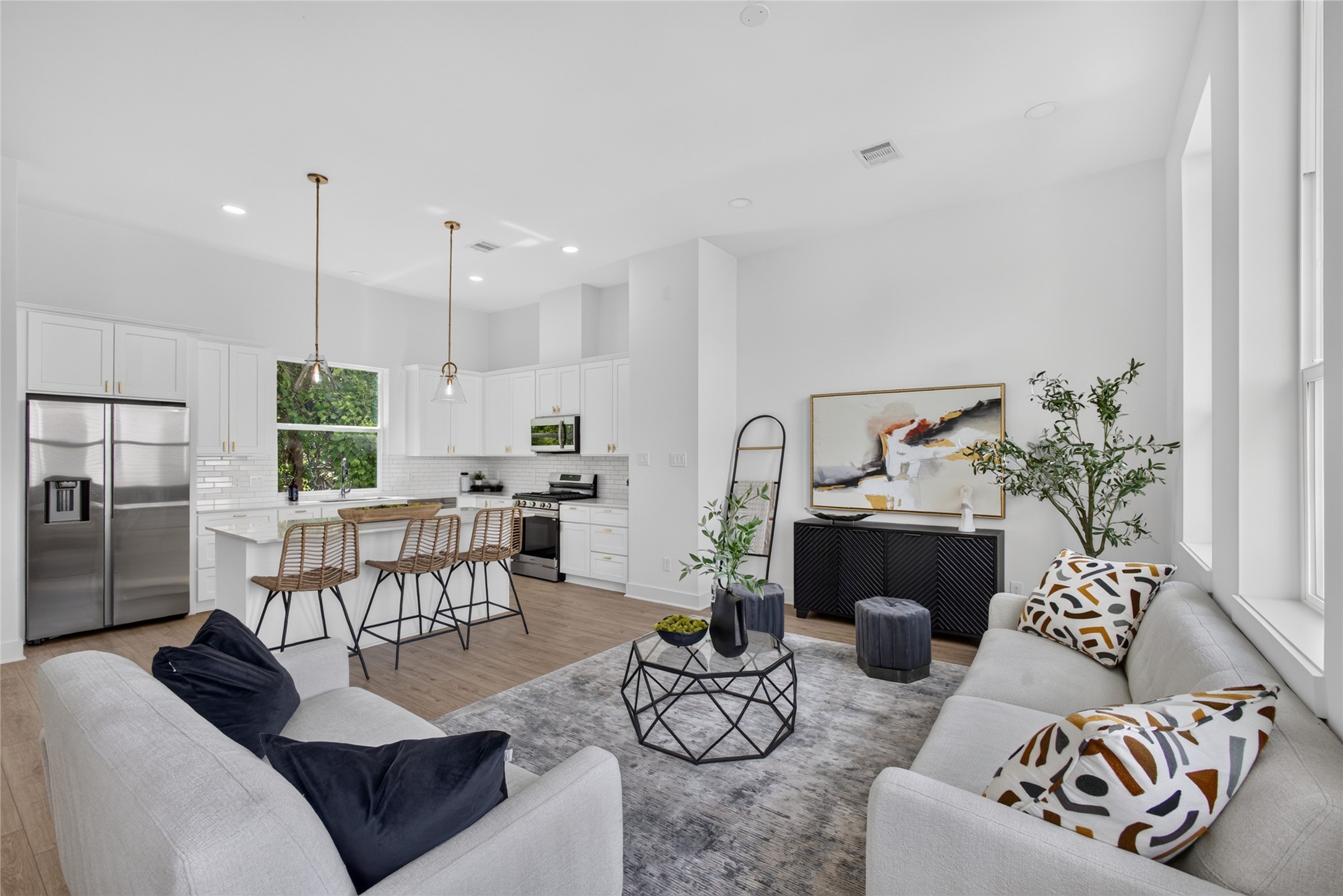 Thoughtfully designed open concept floor plan with engineered hardwood flooring and effortless flow between the kitchen, dining, and living areas.