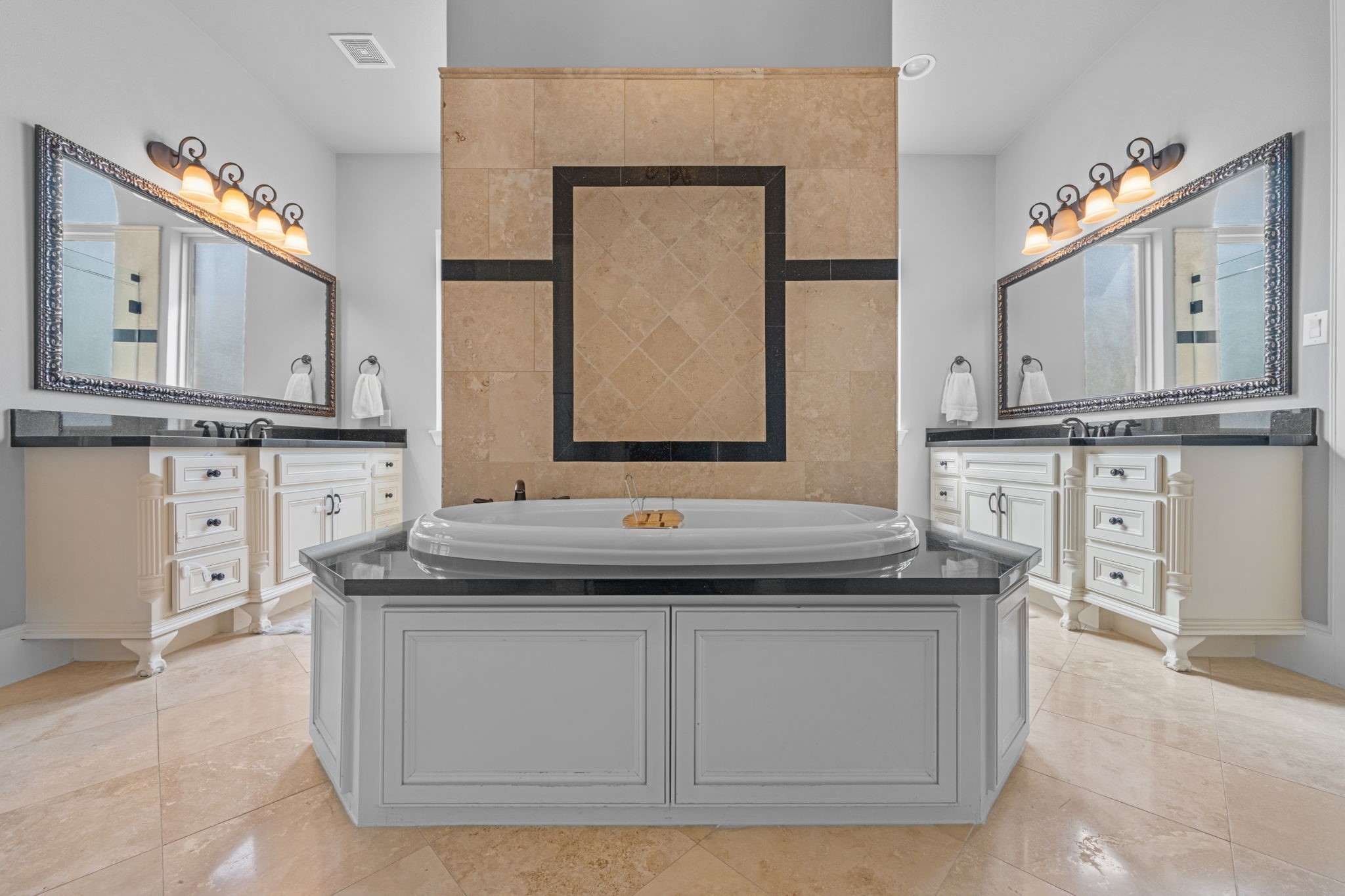 Spa-like primary bath with separate vanities, soaking tub, and generous storage Spa-like primary bath with separate vanities, soaking tub, and generous storage