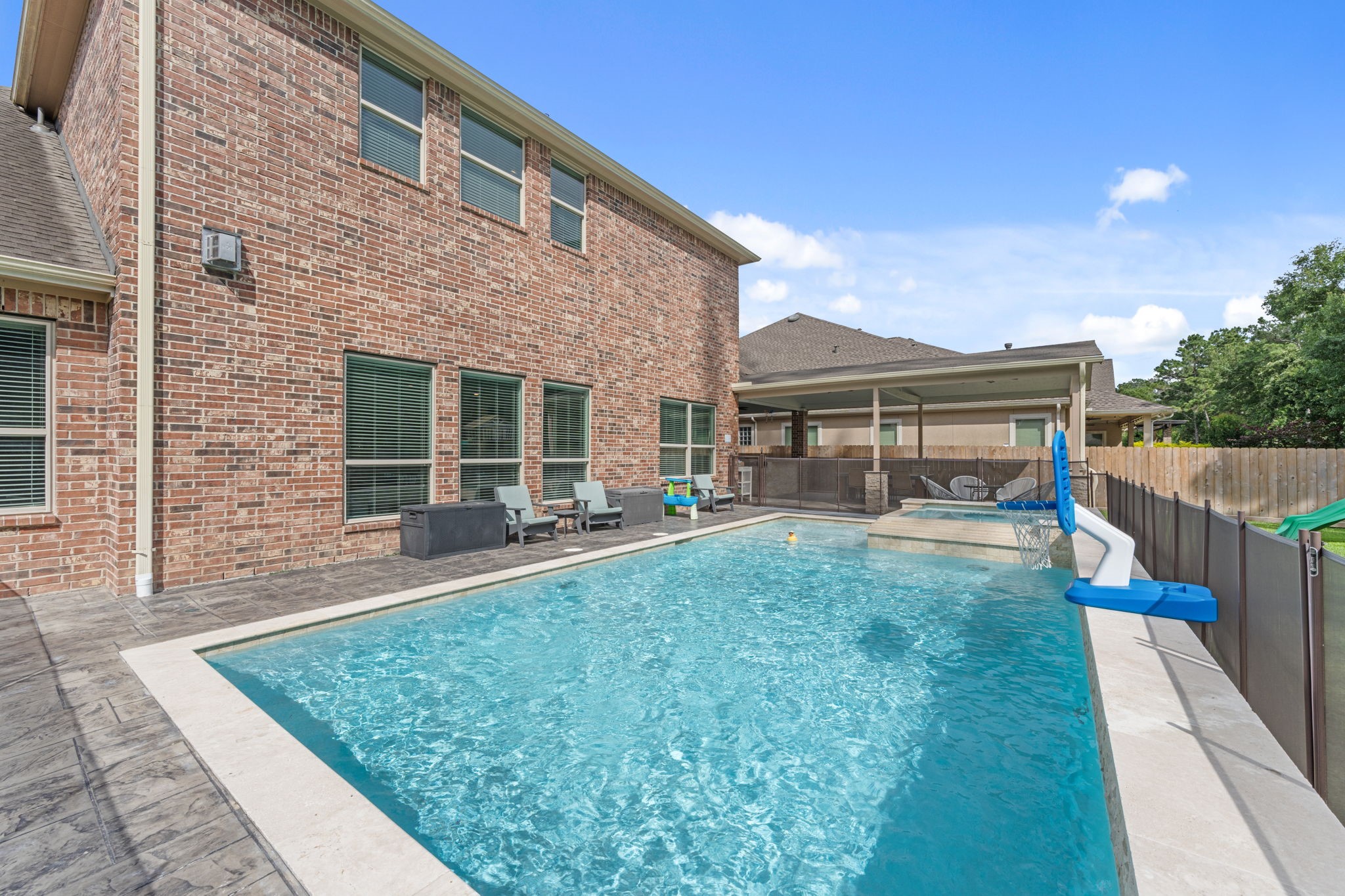 Private backyard retreat with sparkling pool and relaxing hot tub