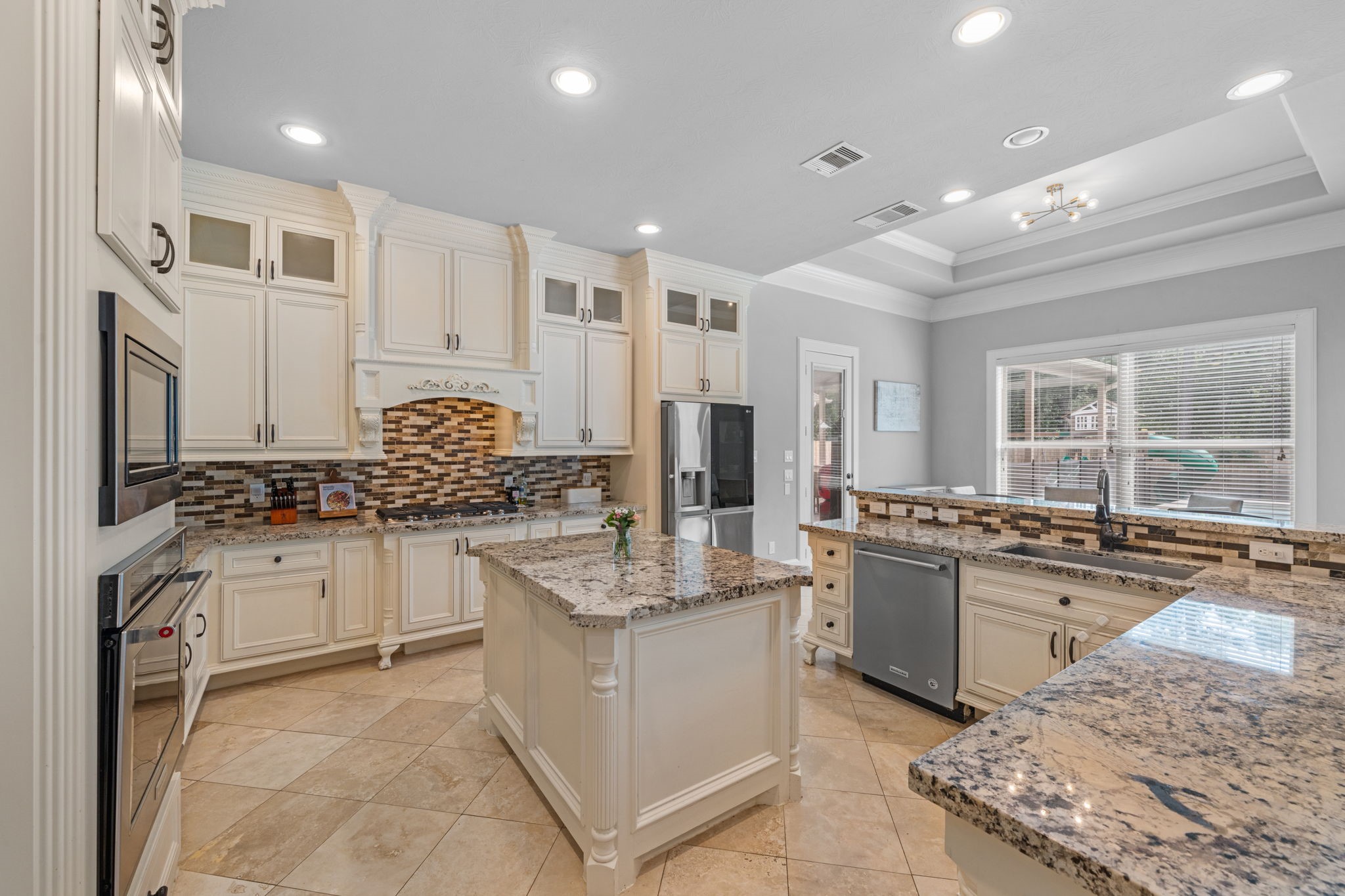 Chef-inspired kitchen with oversized island, abundant cabinetry, and upscale design details