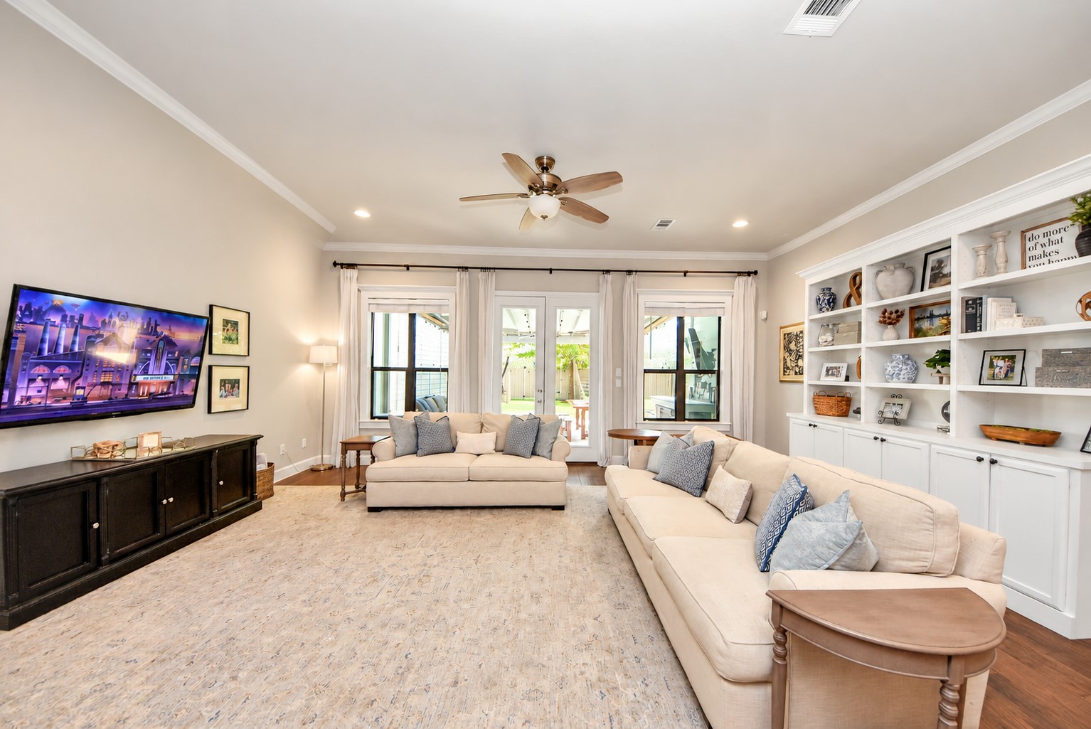 Another view of the primary living area showcasing large windows, custom built-in cabinetry, and an inviting atmosphere.