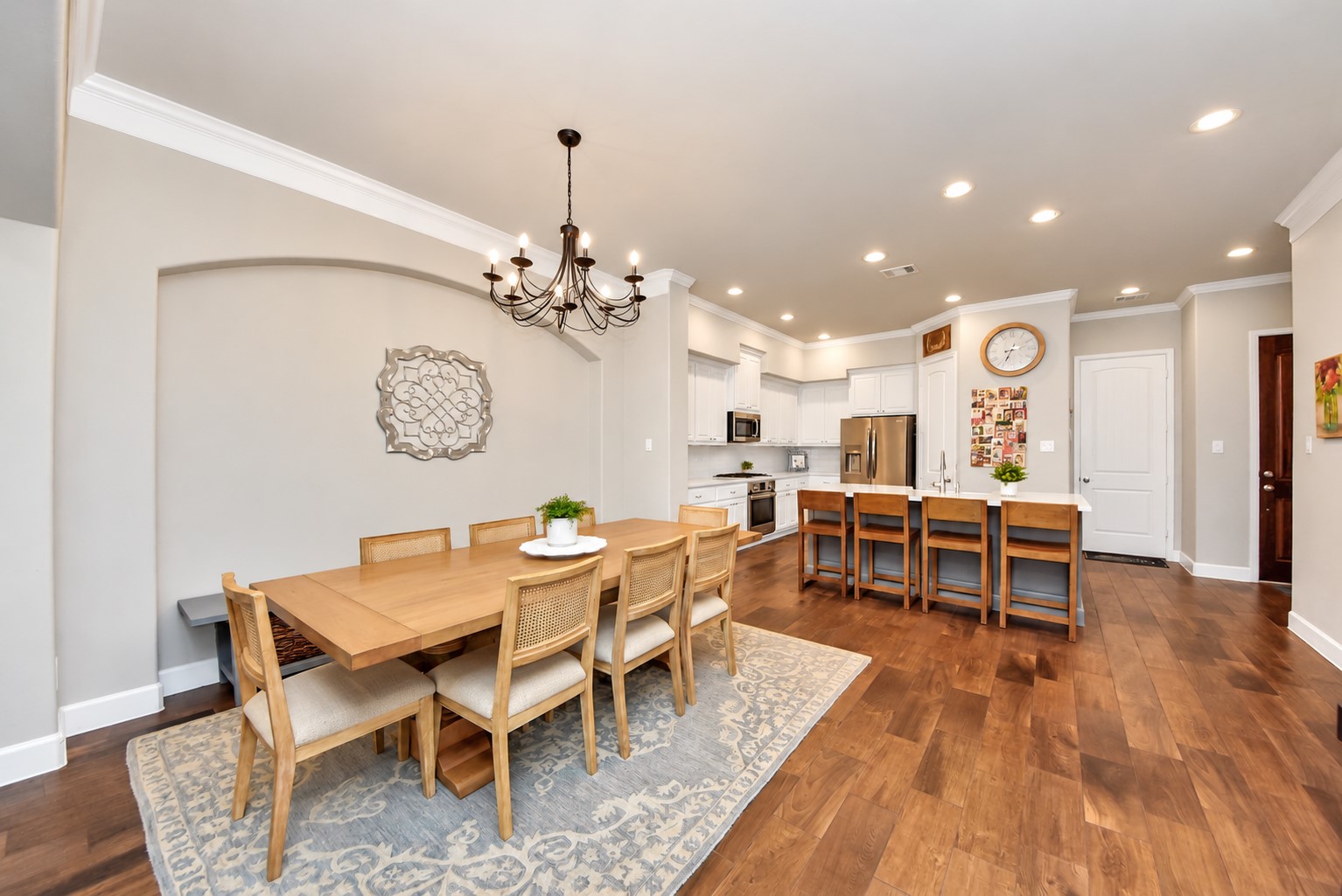 Inviting dining area with elegant architectural arches, a statement chandelier, and seamless access to the living room.