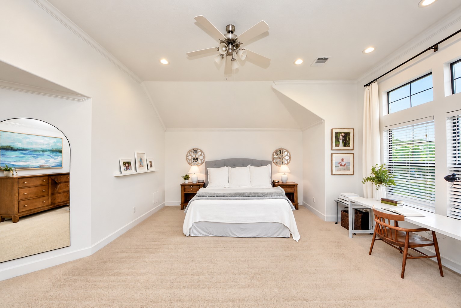 Beautiful primary suite with architectural ceiling details, large windows, and plenty of room for additional furniture.