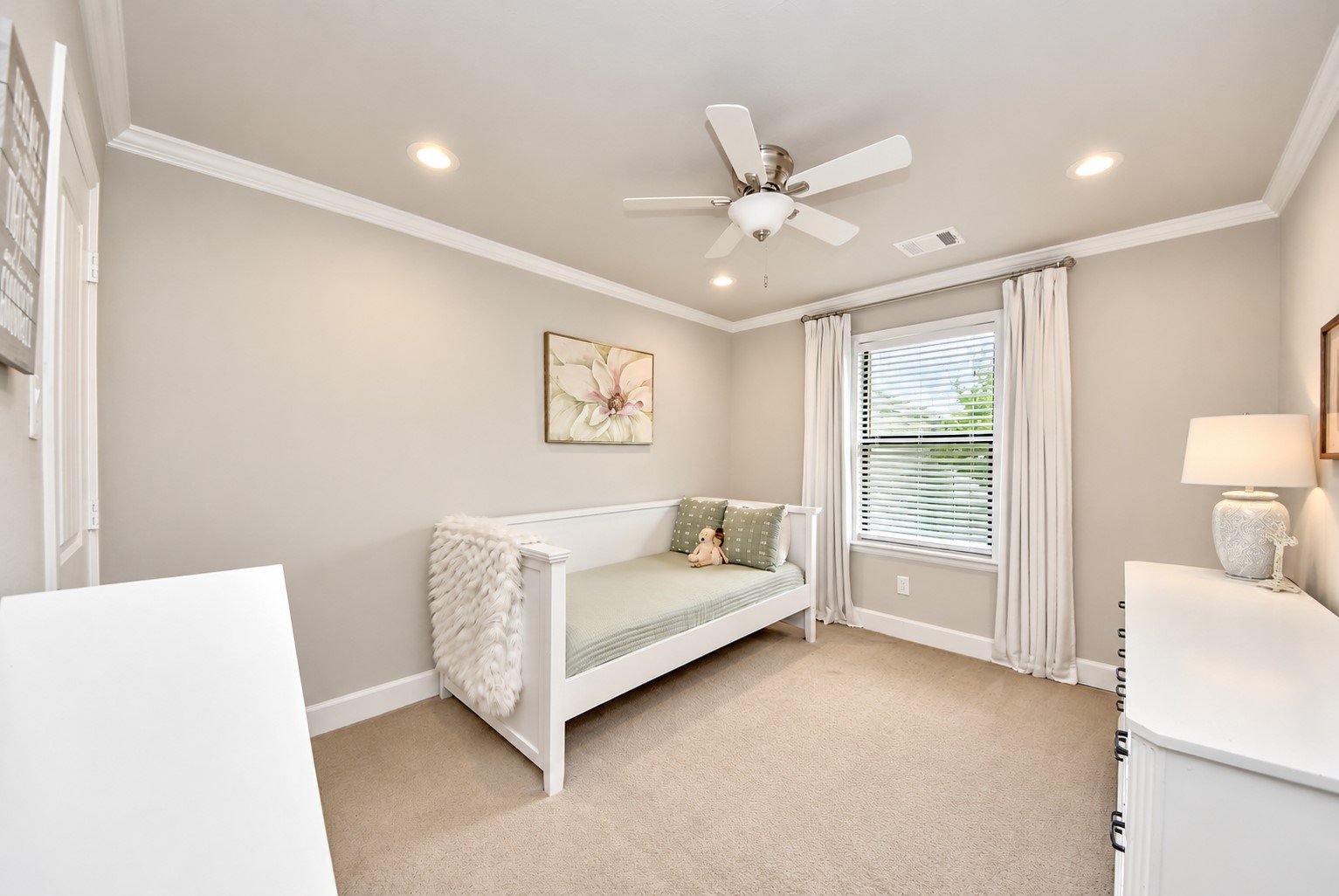 Inviting bedroom featuring crown molding, recessed lighting, a ceiling fan, and abundant natural light. A versatile space that can accommodate a variety of needs.