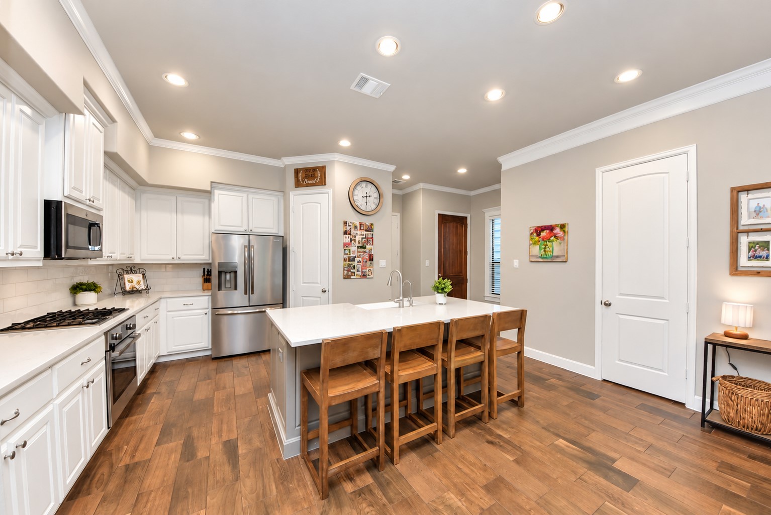Bright, spacious kitchen with an oversized island, abundant cabinetry, stainless steel appliances, and recessed lighting. Bright, spacious kitchen with an oversized island, abundant cabinetry, stainless steel appliances, and recessed lighting.