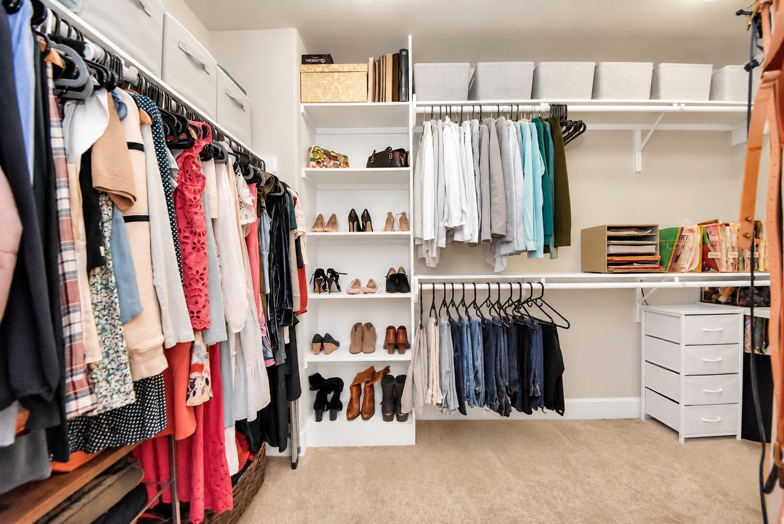 Spacious primary walk-in closet featuring extensive hanging space, built-in shelving, and organized storage for clothing, shoes, and accessories.