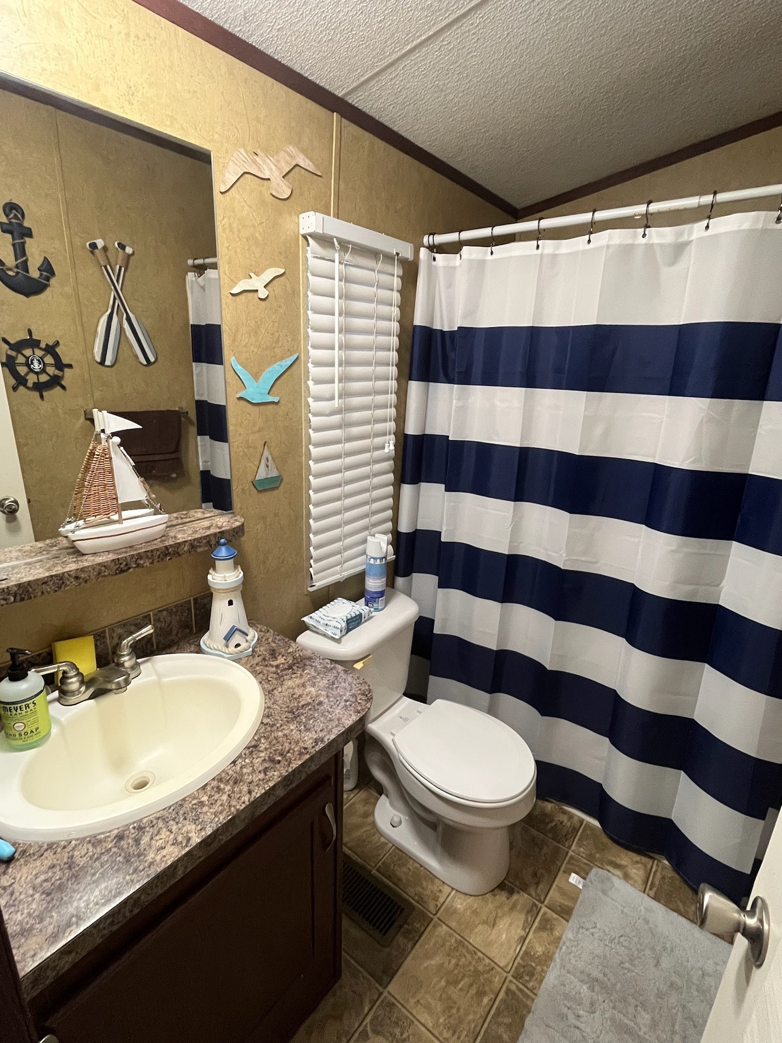 The secondary bath has a tub/shower combo and a single vanity/sink.