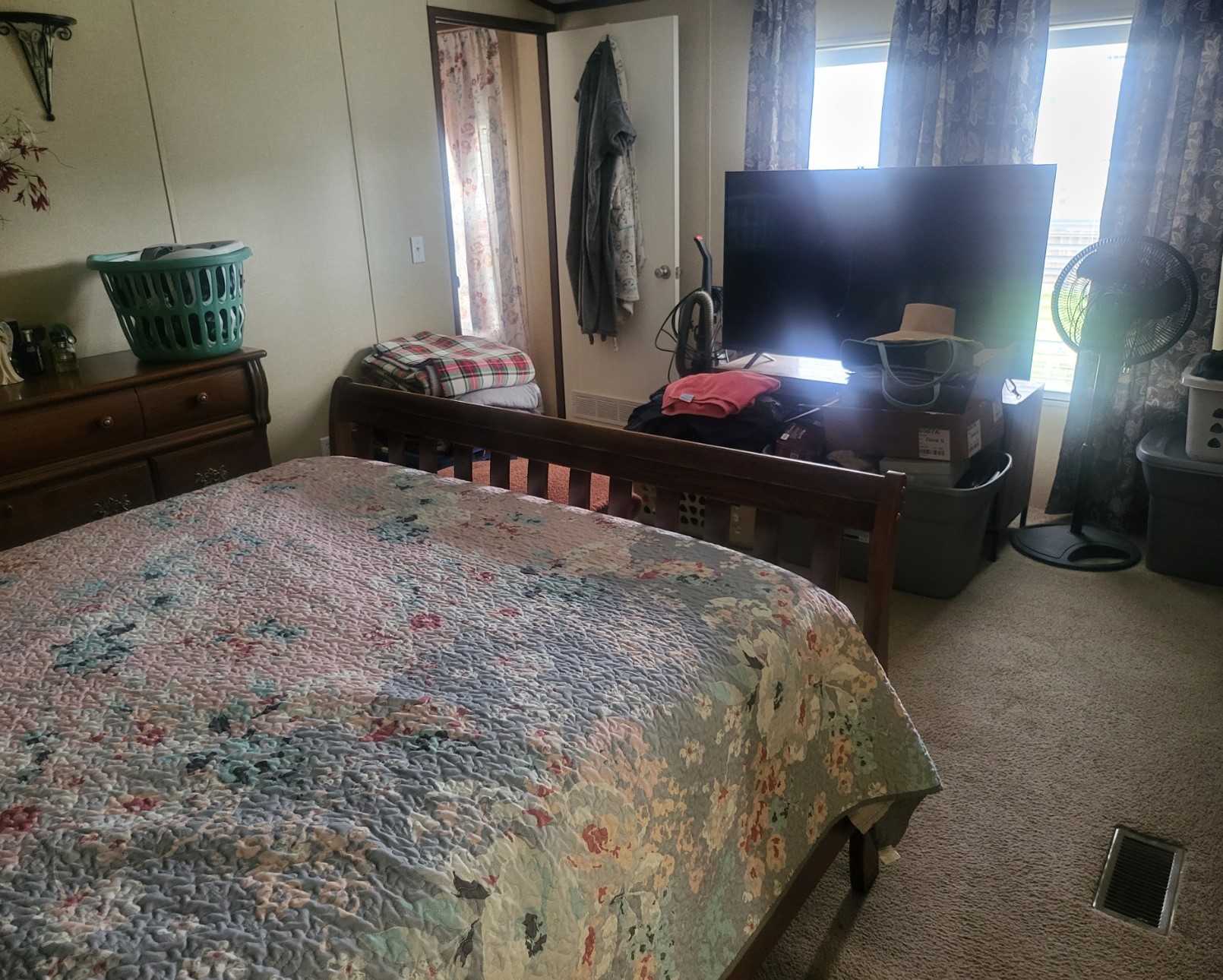 The primary bedroom comfortably accommodates a queen-size bed, full dresser and a large tv with room left over.