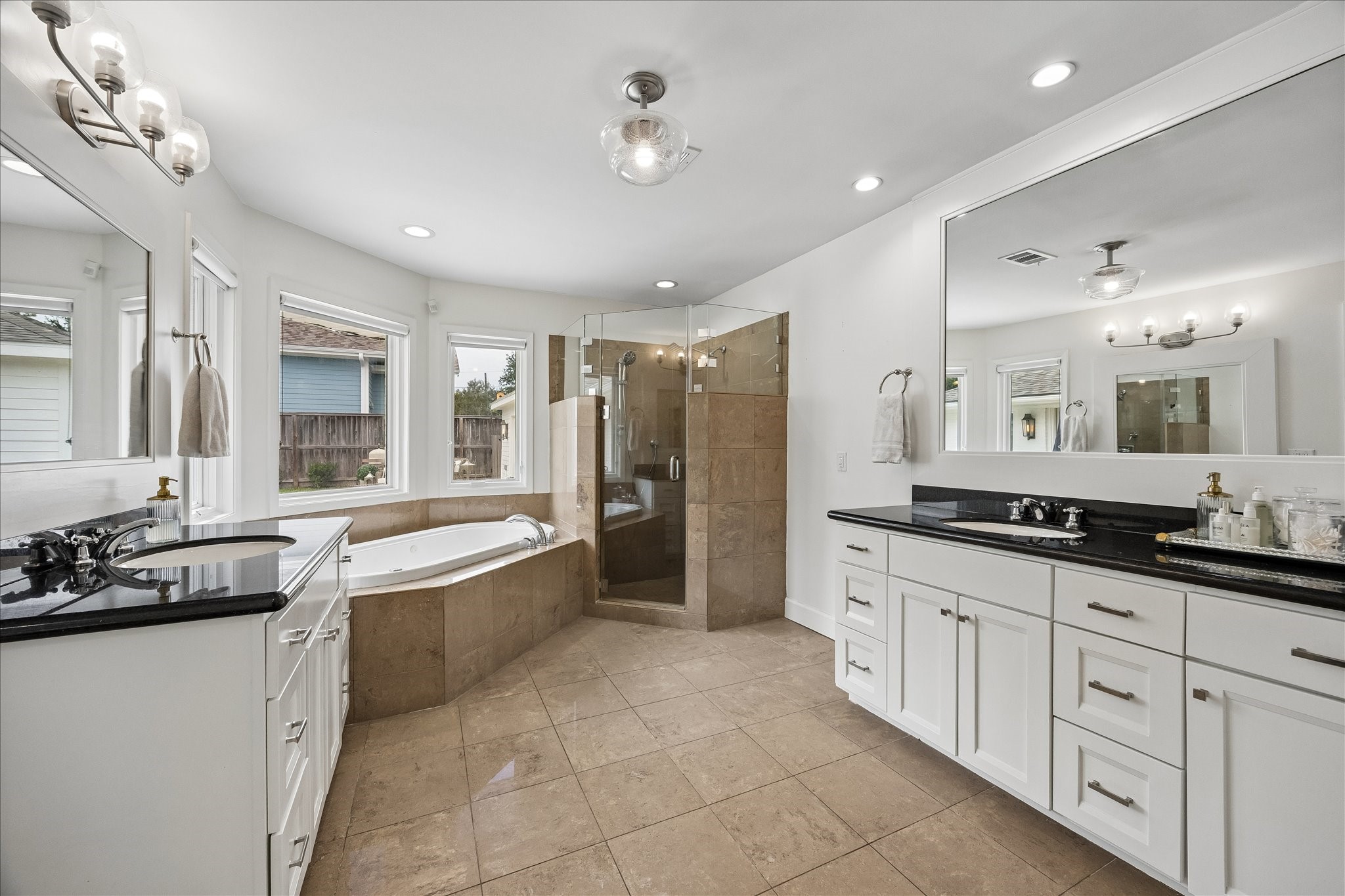 Dual vanities, jetted tub, and separate shower in this nicely sized primary bath.