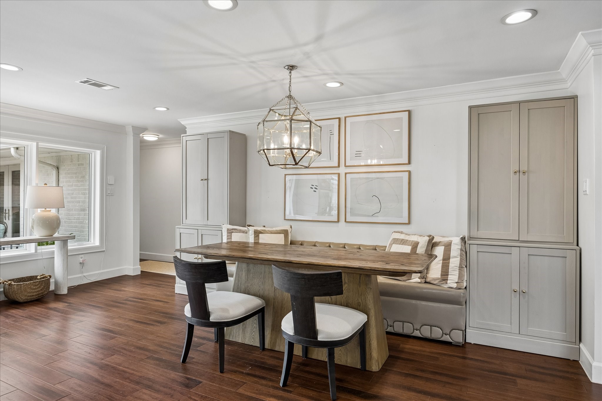 Stylish banquette flanked by cabinets and accented by Visual Comfort pendant light. Stylish banquette flanked by cabinets and accented by Visual Comfort pendant light.