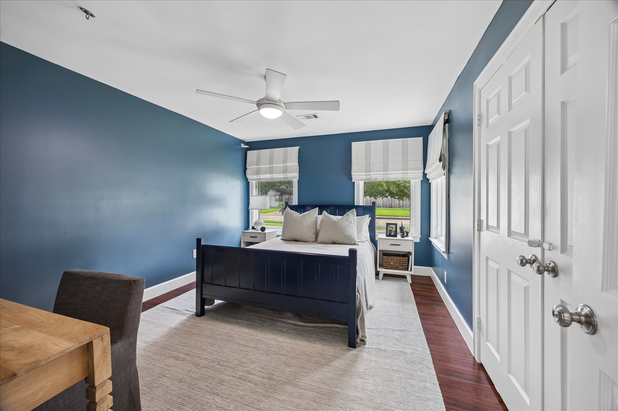 Secondary bedroom with custom, roman shades.