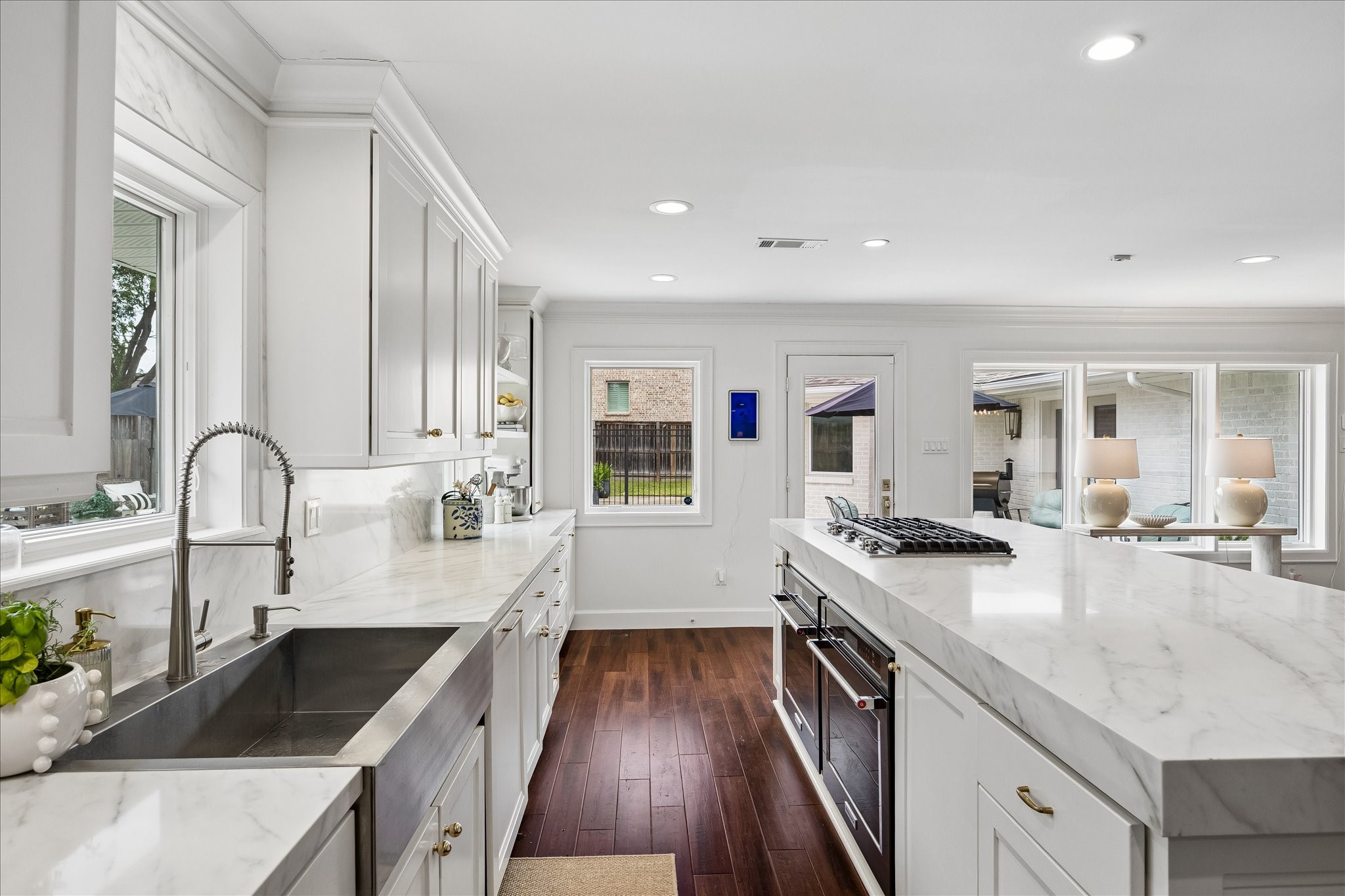 Gorgeous kitchen renovated (2025) with stainless sink, Symphony Quartz on the island, counters and ceiling height backsplash. KitchenAid ovens and cooktop with new Bosch dishwasher. Gorgeous kitchen renovated (2025) with stainless sink, Symphony Quartz on the island, counters and ceiling height backsplash. KitchenAid ovens and cooktop with new Bosch dishwasher.