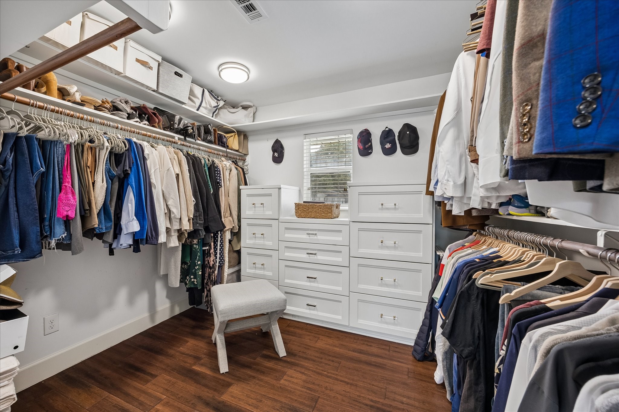 HUGE primary closet with ample storage and hanging.