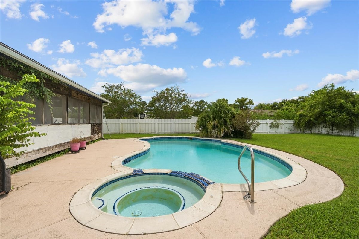 Pool and hot tub area. Pool has a deep end and diving board has been removed for insurance purposes.