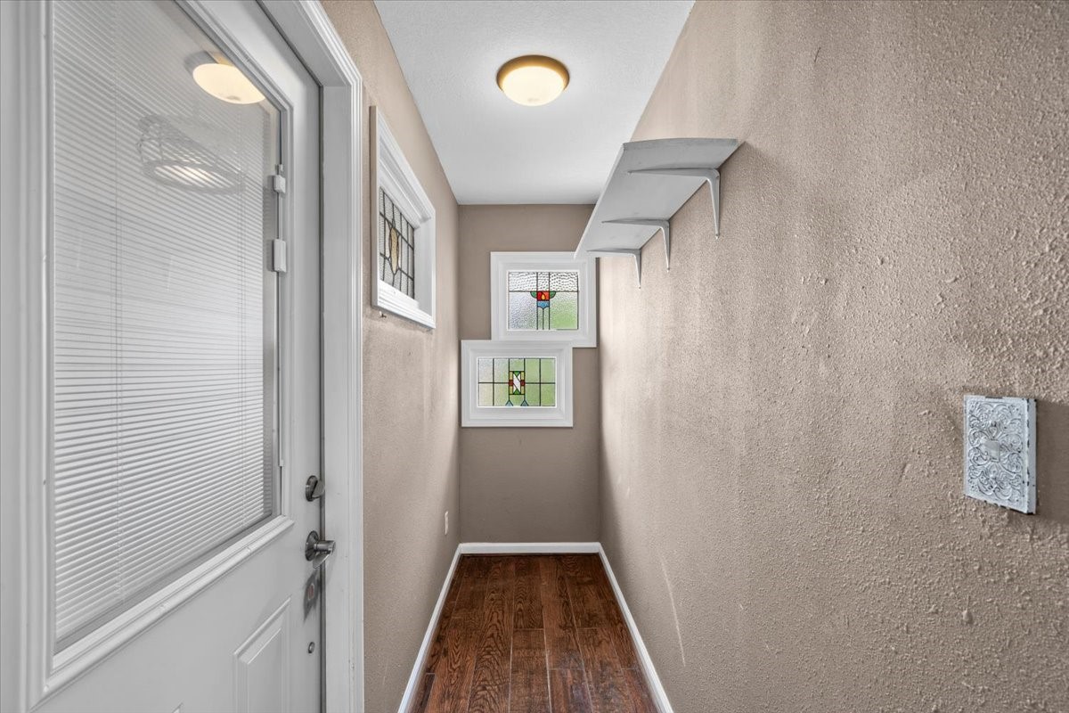 Hallway with secondary door to backyard.