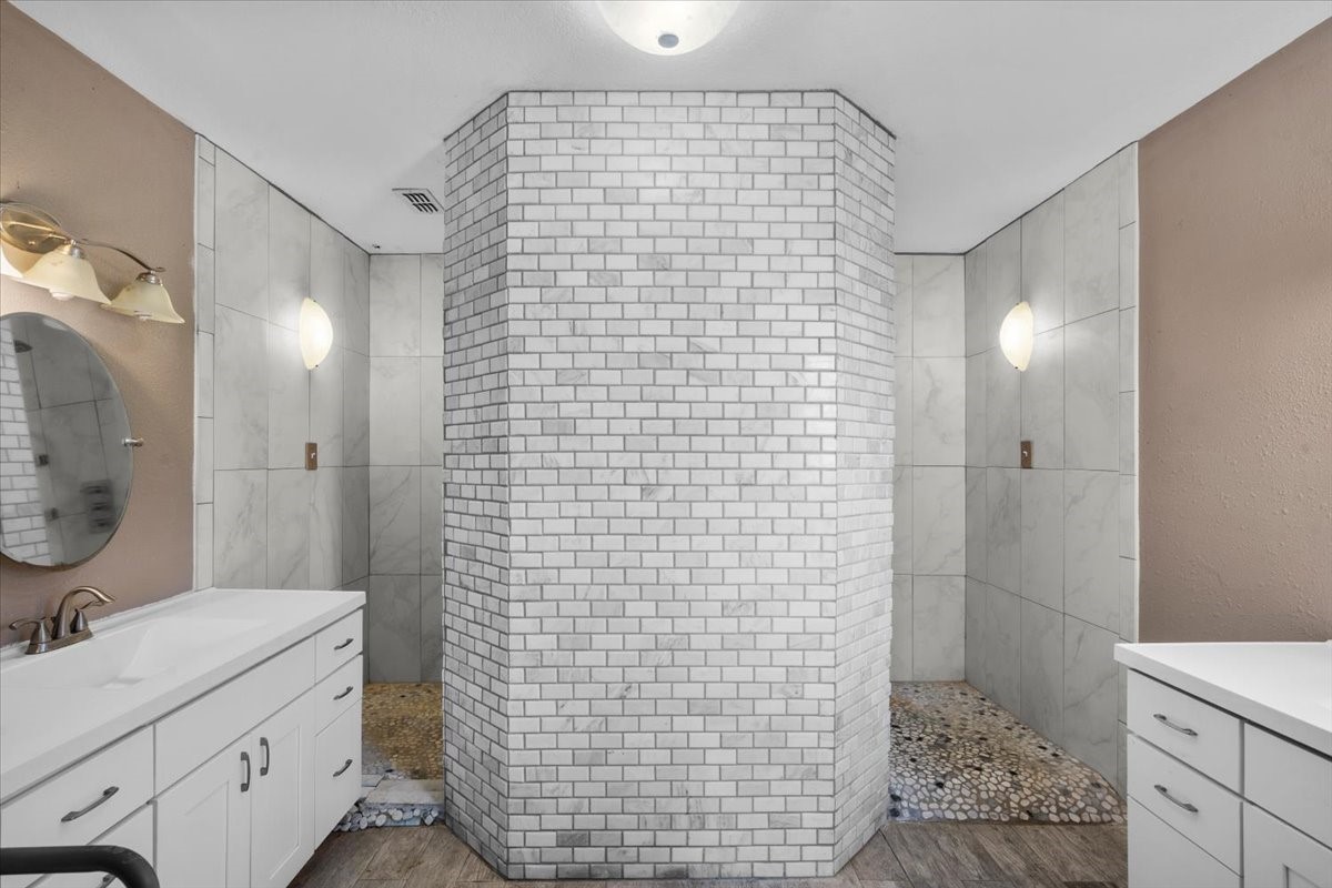 Primary bathroom with double sinks and large shower.