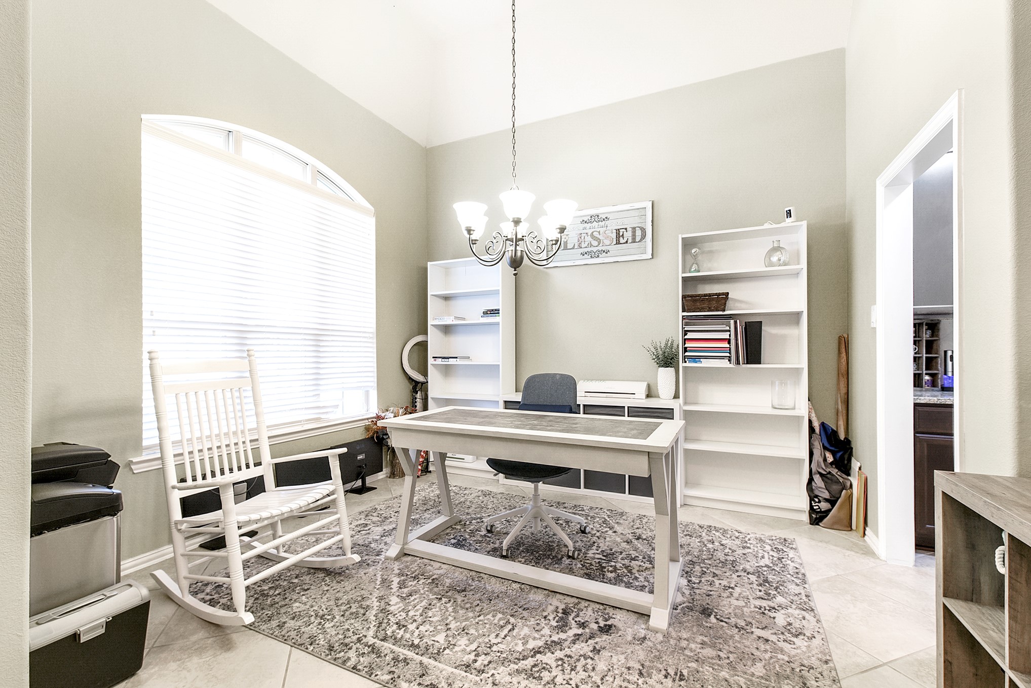 The formal dining space boasts the same elegant tile flooring and offers delightful views of the front yard. Currently utilized as a home office due to the spacious breakfast room, providing versatile living options.