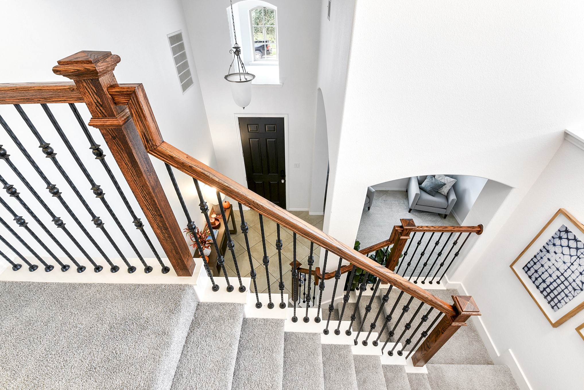 A view from upstairs showcases the front door, offering a glimpse of the homes entryway and the natural light that fills the space.