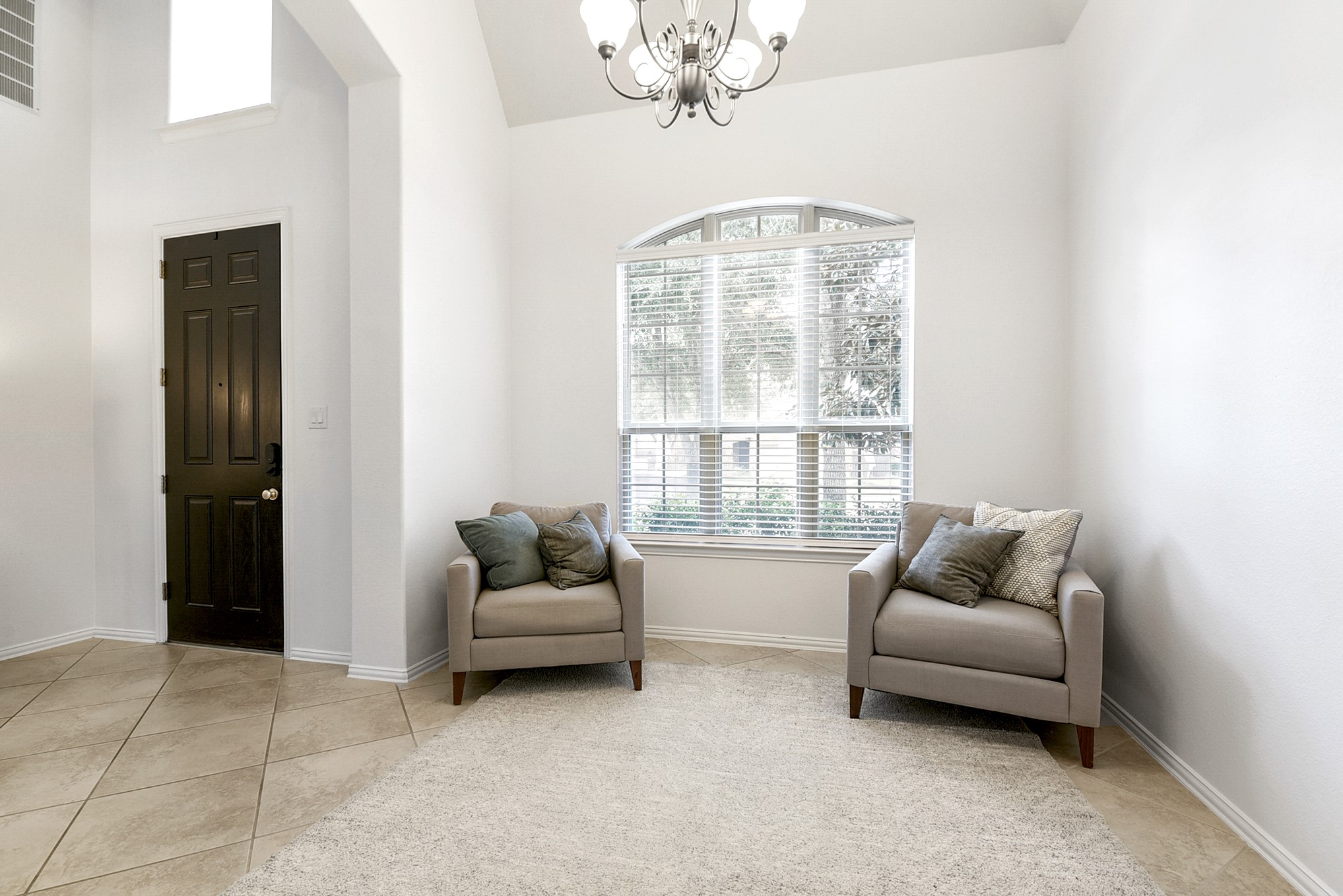 Another view of this formal dinning room, den or additional seating area, perfect for a home office on the main floor. The photo currently shows it being used as a sitting area. Offer same tile throught out the home.