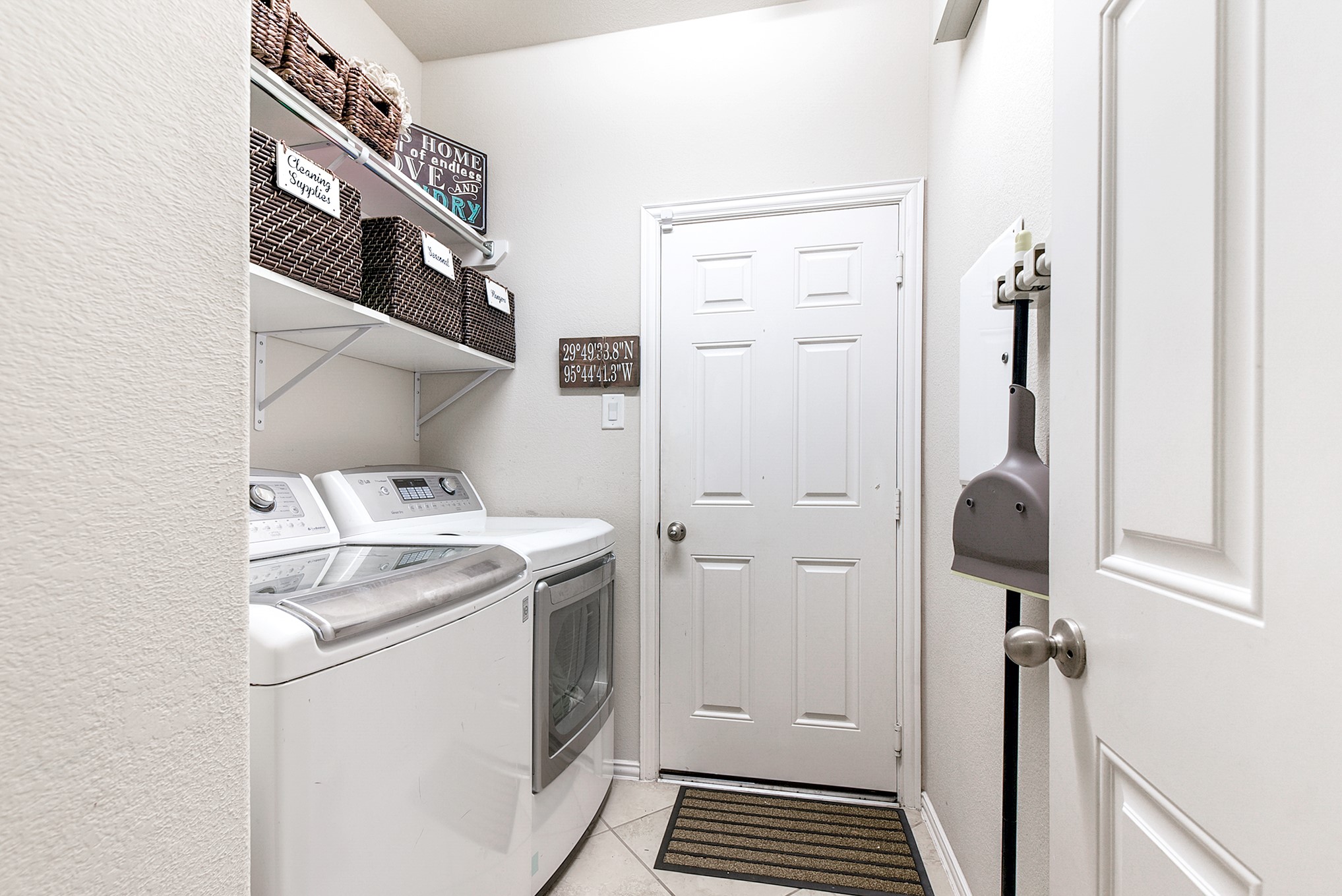 Downstairs, you'll find the utility room conveniently located, leading into the garage. The washer and dryer come included with the home, and you'll notice the extra shelving for added storage and organization.